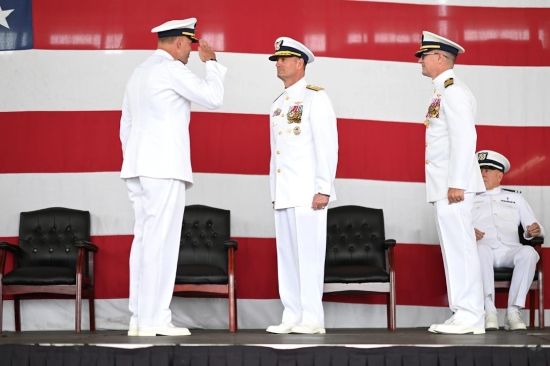Capt. Robert Tucker relieves Capt. Patrick Dill as the Coast Guard Sector San Diego commander during a change of command ceremony in San Diego, June 13, 2025. Rear Adm. Joseph Buzzella, the 11th Coast Guard District commander, presided over the time-honored military tradition that represents a formal transfer of authority and responsibility for a unit from one commanding officer to another. (U.S. Coast Guard photo by Petty Officer 1st Class Adam Stanton)
