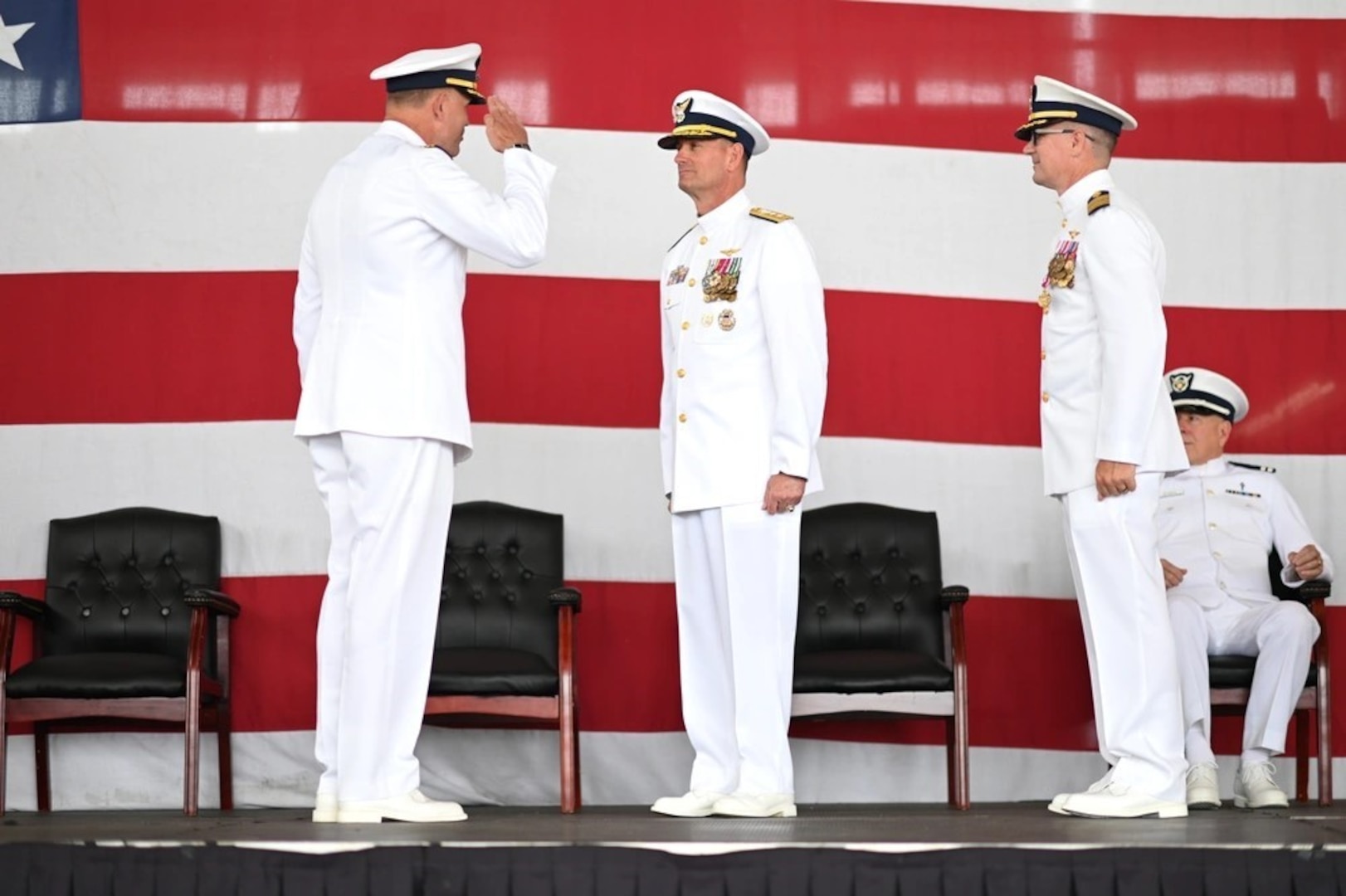 Capt. Robert Tucker relieves Capt. Patrick Dill as the Coast Guard Sector San Diego commander during a change of command ceremony in San Diego, June 13, 2025. Rear Adm. Joseph Buzzella, the 11th Coast Guard District commander, presided over the time-honored military tradition that represents a formal transfer of authority and responsibility for a unit from one commanding officer to another. (U.S. Coast Guard photo by Petty Officer 1st Class Adam Stanton)