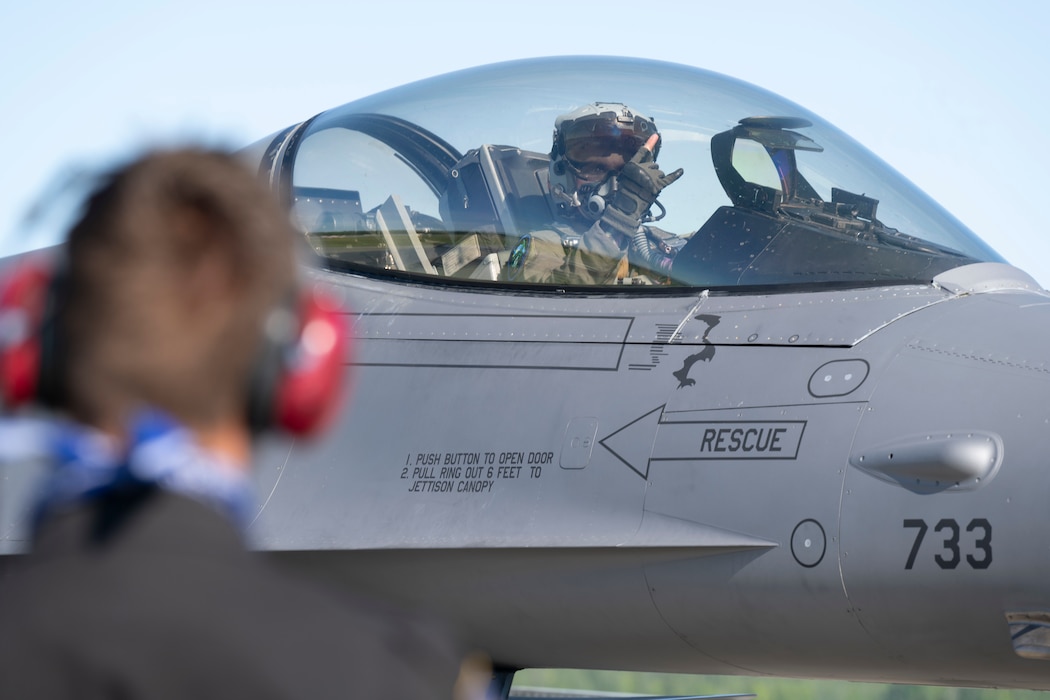 U.S. Air Force Capt. Joshua Blue, 36th Fighter Squadron F-16 Fighting Falcon pilot, gives the 36th FS “Push It Up” hand signal to Senior Airman Mason Roberts, 35th Fighter Generation Squadron dedicated crew chief, prior to departure from Eielson Air Force Base, Alaska, June 13, 2025.