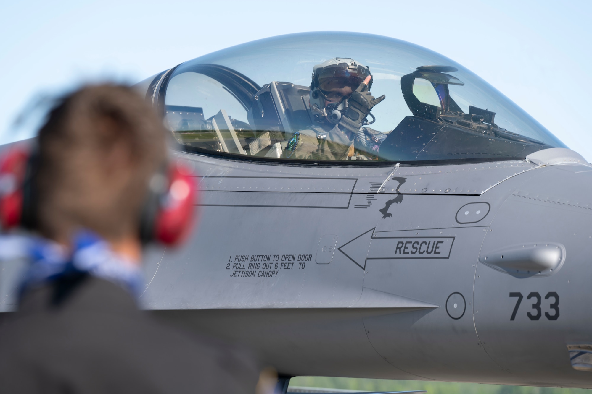U.S. Air Force Capt. Joshua Blue, 36th Fighter Squadron F-16 Fighting Falcon pilot, gives the 36th FS “Push It Up” hand signal to Senior Airman Mason Roberts, 35th Fighter Generation Squadron dedicated crew chief, prior to departure from Eielson Air Force Base, Alaska, June 13, 2025.