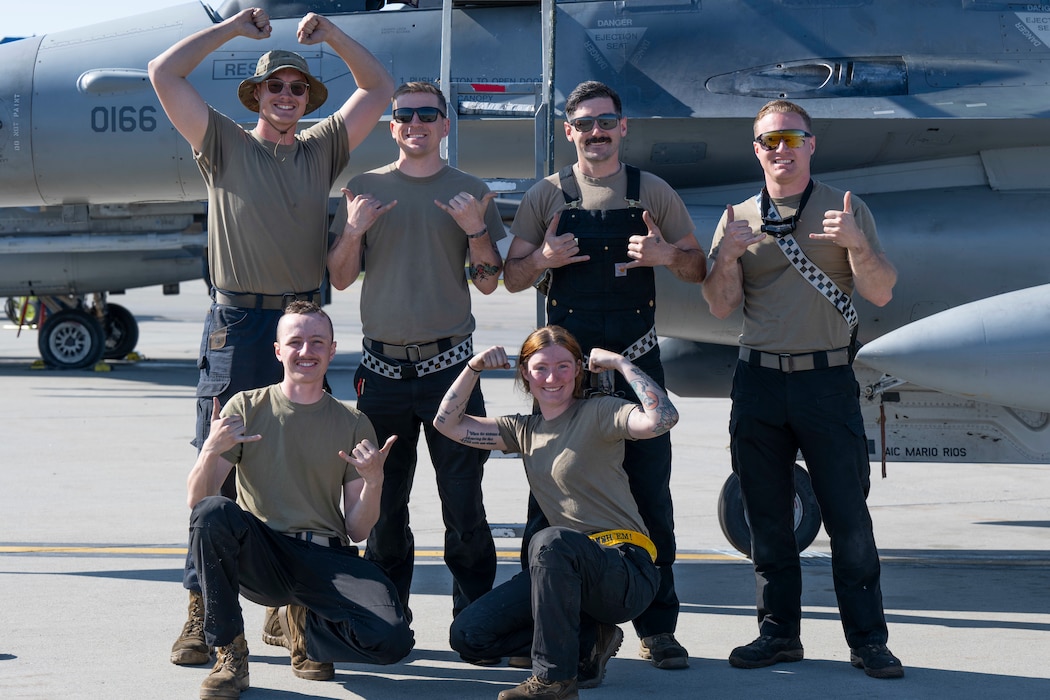 Crew chiefs from the 35th Fighter Generation Squadron give the 35th FGS “Push It Up” hand signal and “Crush ‘Em” hand signal in front of an F-16 Fighting Falcon during Red Flag-Alaska 25-2, at Eielson Air Force Base, Alaska, June 13, 2025.