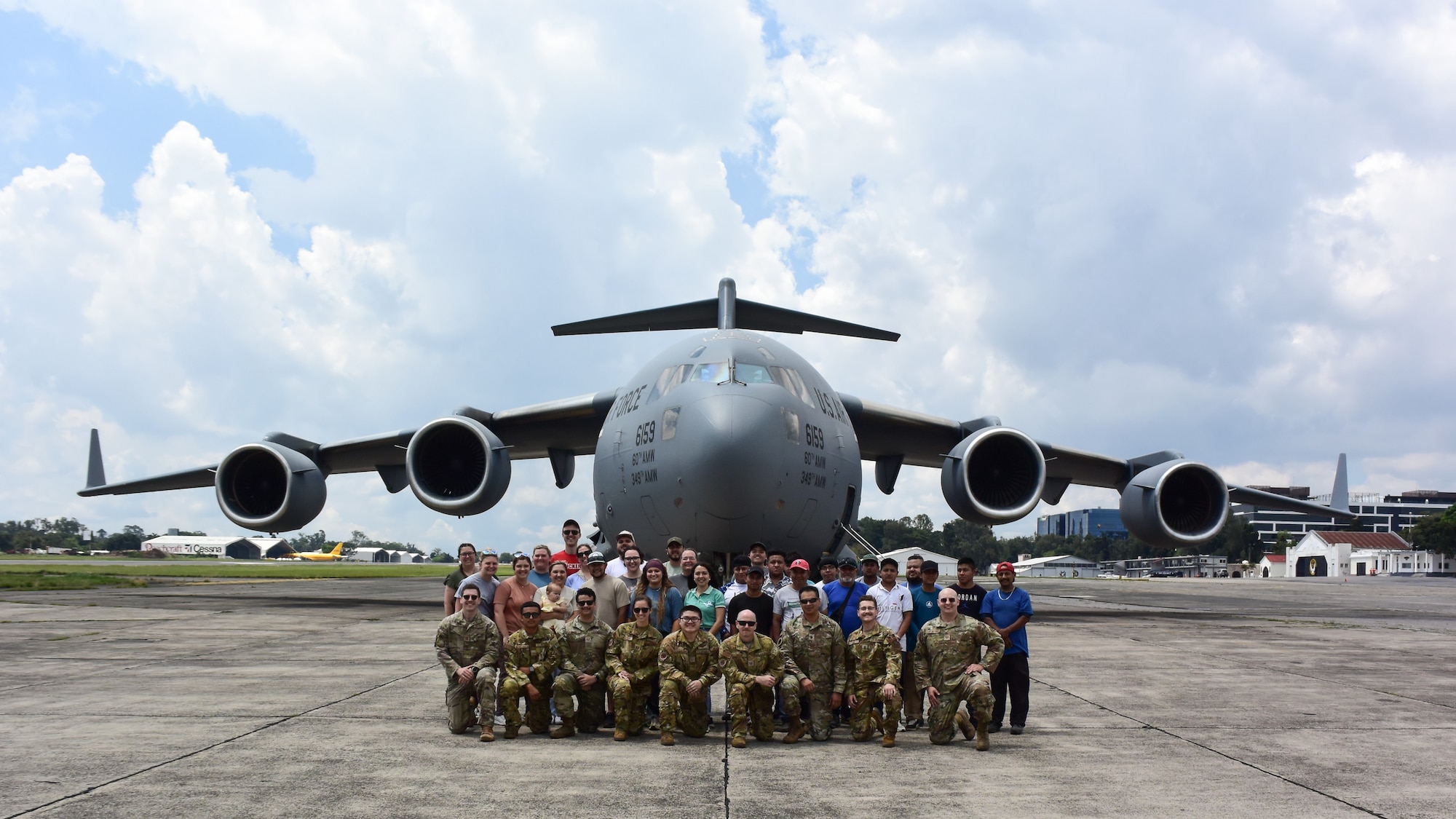 Group photo in front of aircraft