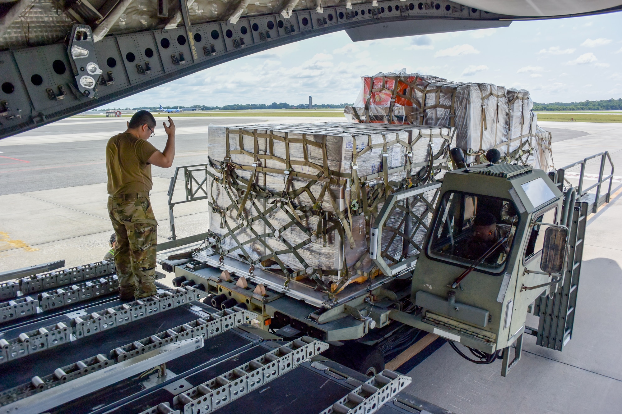 Airman directs cargo on to aircraft