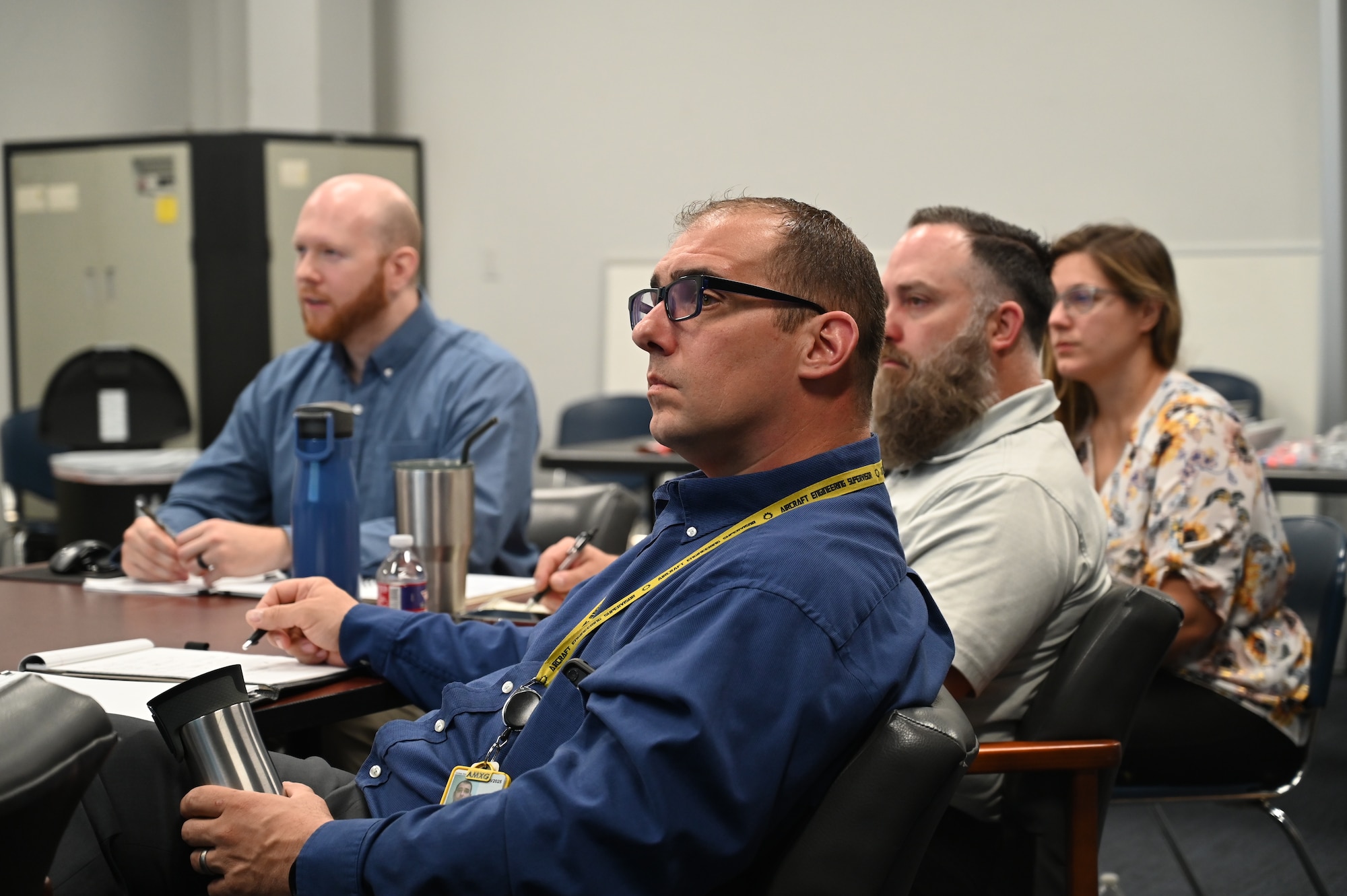 Several employees view a presentation