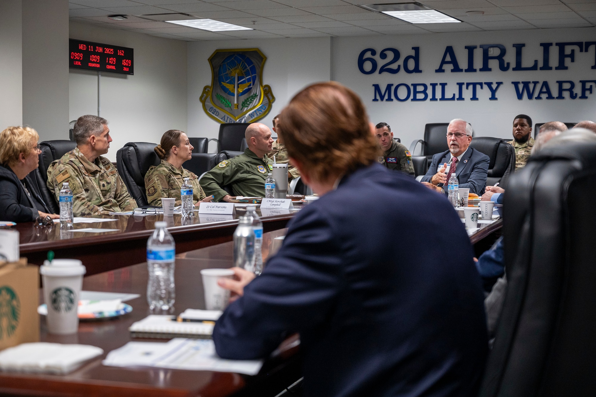 Members of the Defense Orientation Conference Association and Team McChord leadership discuss the 62d Airlift Wing’s and 627th Air Base Group’s mission sets at Joint Base Lewis-McChord, Washington, June 11, 2025.