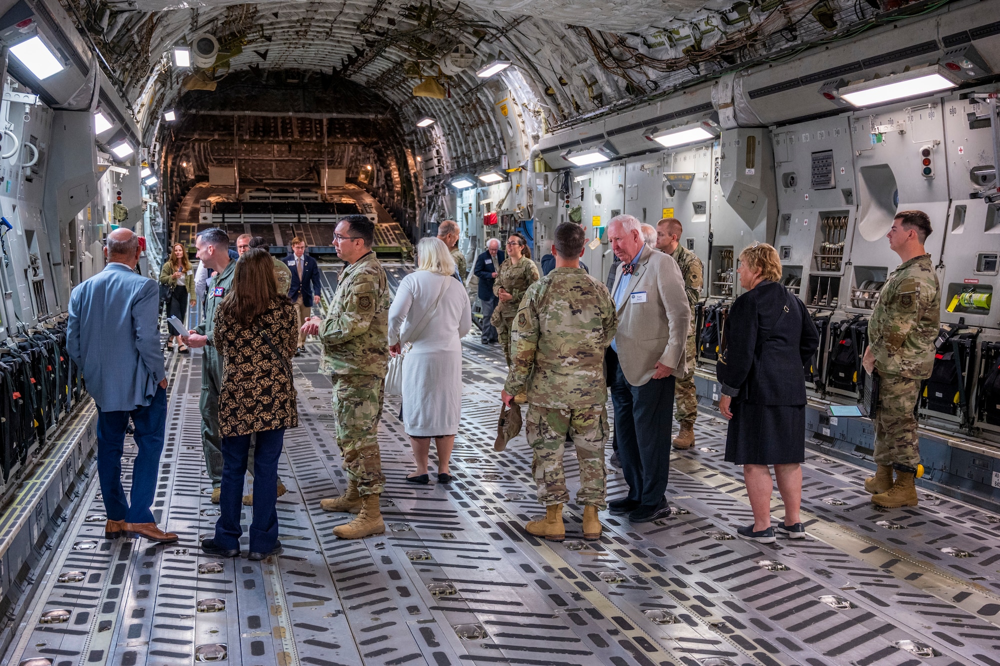 Members of the Defense Orientation Conference Association and Team McChord Airmen discuss C-17 Globemaster III functions at Joint Base Lewis-McChord, Washington, June 11, 2025.