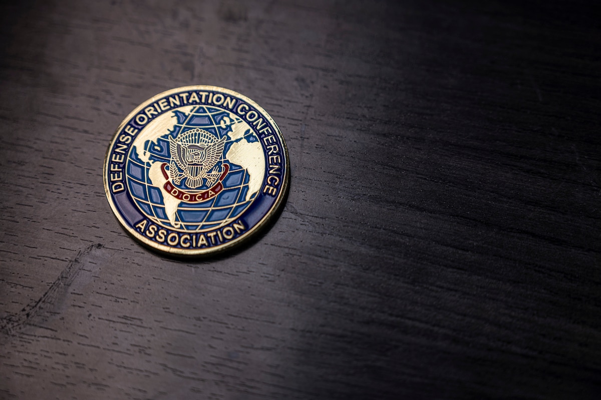 A Defense Orientation Conference Association coin lays on a desk at Joint Base Lewis-McChord, Washington, June 11, 2025.