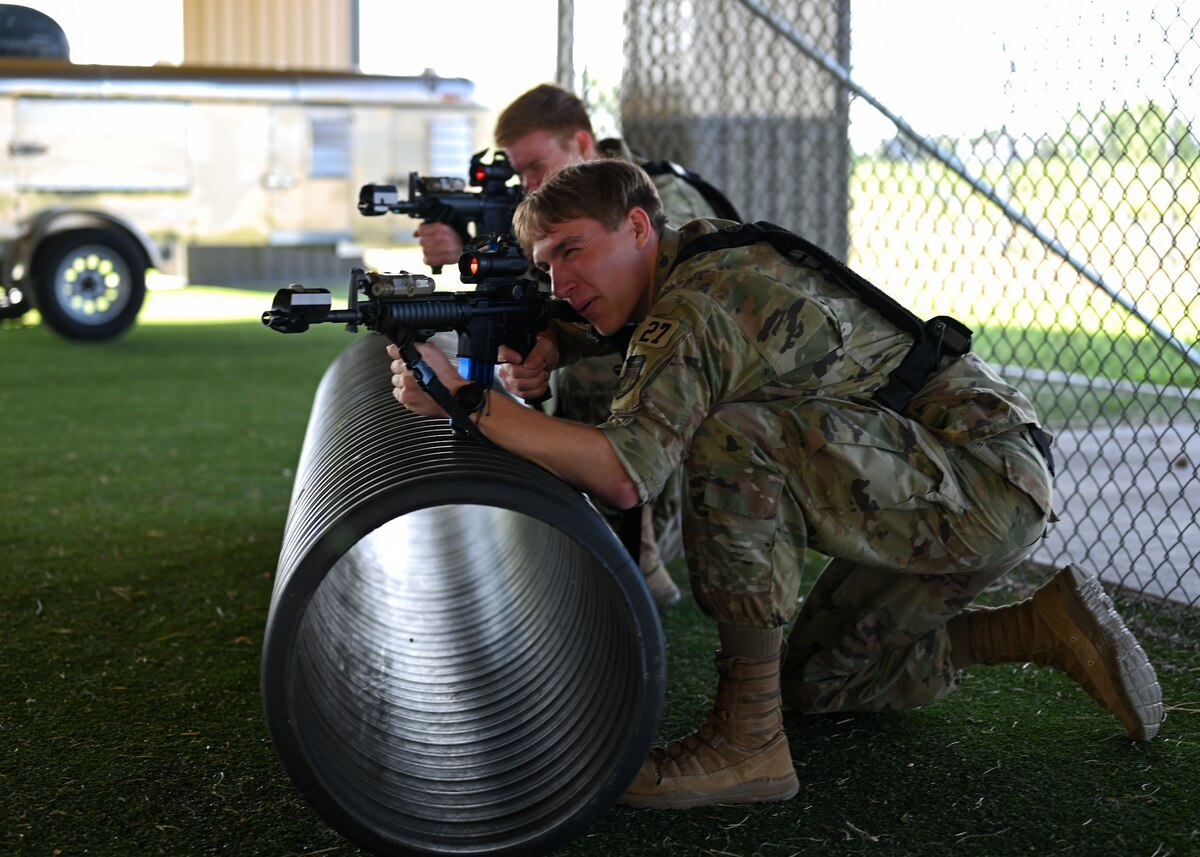 U.S. Air Force Academy cadets practice small unit tactics during the OPS Air Force Goodfellow Air Force Base visit at the 17th Security Forces Squadron kennels, Goodfellow AFB, Texas, June 9, 2025. Small unit movements for security forces involve tactics and techniques employed by small units, like platoons or squads, to move through an area while maintaining security.  (U.S. Air Force Senior Airman Evelyn J. D’Errico)