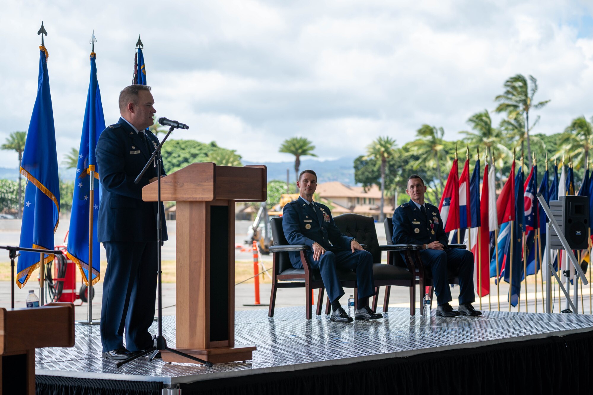 A U.S. Air Force commander addresses a crowd speaking at a podium.