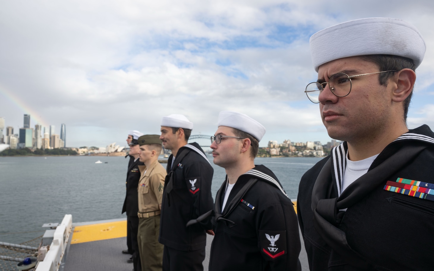 250614-N-PV363-1071 SYDNEY, Australia (June 14, 2025) Sailors assigned to the forward-deployed amphibious assault ship USS America (LHA 6) and Marines assigned to the 31st Marine Expeditionary Unit (MEU) man the rails onboard America, while in Sydney, June 14. America, lead ship of the America Amphibious Ready Group, is operating in the U.S. 7th Fleet area of operations. U.S. 7th Fleet is the U.S. Navy’s largest forward-deployed numbered fleet, and routinely interacts and operates with allies and partners in preserving a free and open Indo-Pacific region. (U.S. Navy photo by Mass Communication Specialist 3rd Class Darian Lord)