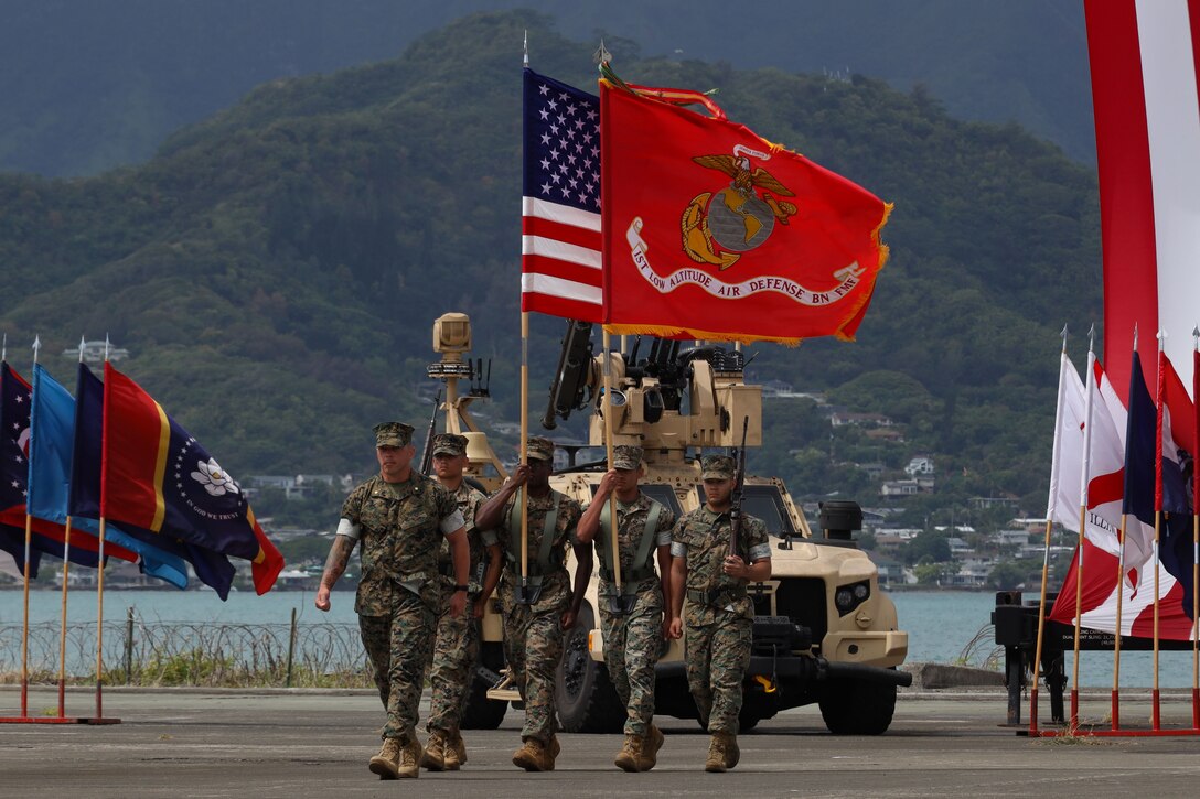 U.S. Marines with 1st Low Altitude Air Defense Battalion (LAAD), Marine Air Control Group 18, 1st Marine Aircraft Wing march on the colors during a change of command ceremony at Marine Corps Air Station Kaneohe Bay, Hawaii, June 12, 2025. Lt. Col. Heath A. Phillips relinquished his duties as commanding officer of 1st LAAD to Lt. Col. Douglas A. Columbus. (U.S. Marine Corps photo by Cpl. Anabelle Reed-O’Brien)