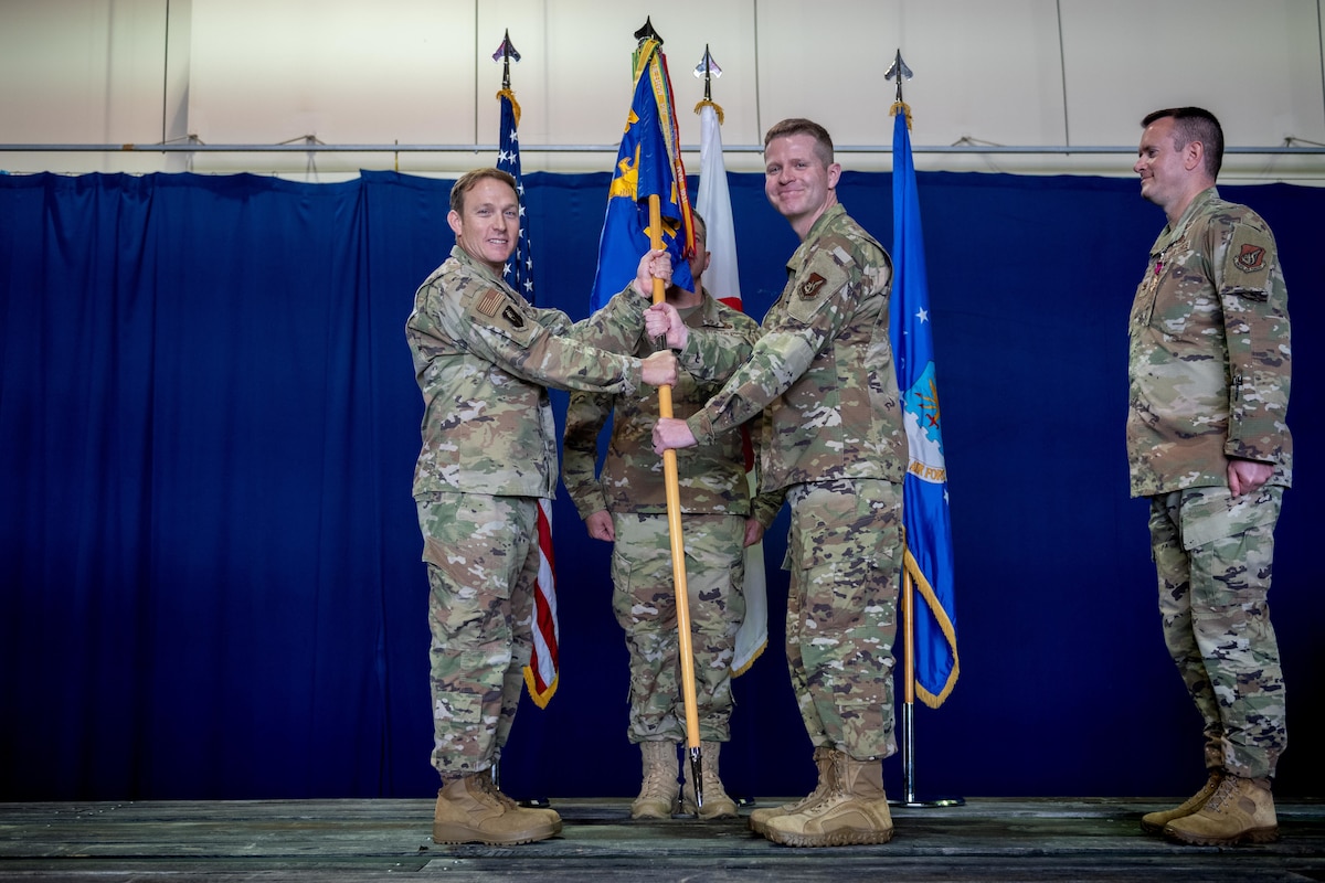 U.S. Air Force Col. Paul Davidson, 35th Fighter Wing commander, passes the group guidon to U.S. Air Force Col. John Conner, incoming 35th Mission Support Group (MSG) commander, as part of a change of command ceremony.