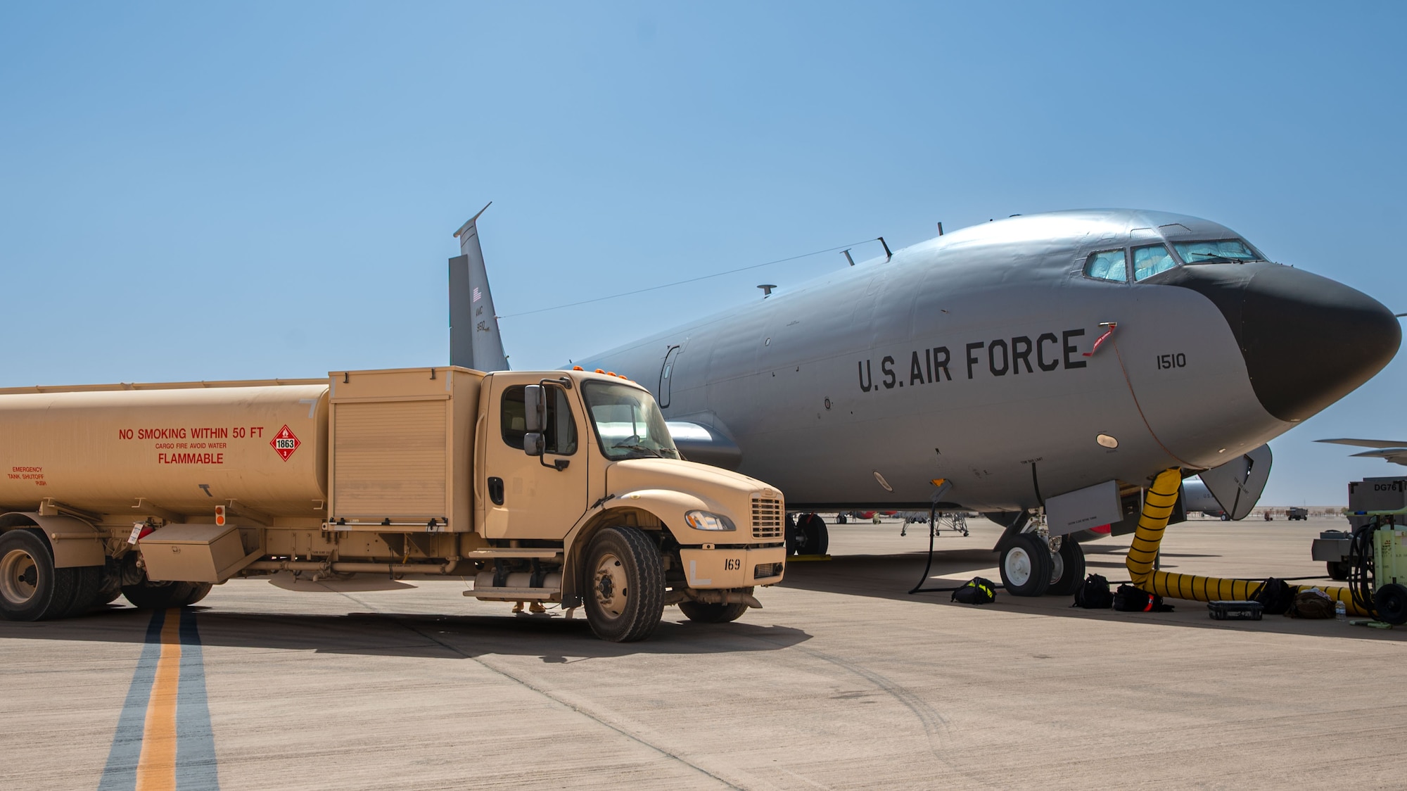 A fuel truck is parked by a KC-135.