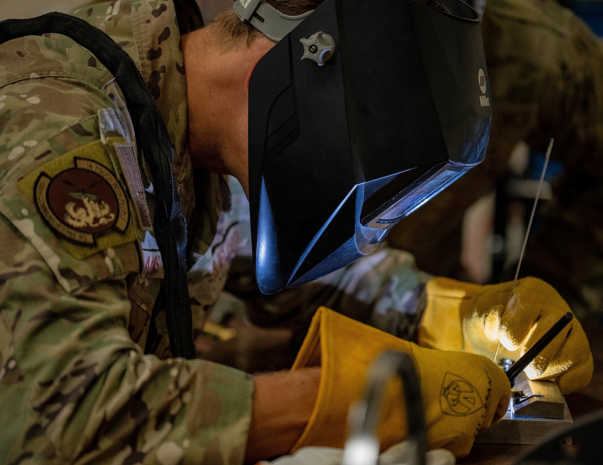 U.S. Air Force Chief Master Sgt. Markus Annis, 100th Communications Squadron senior enlisted leader, practices welding processes on pieces of stainless steel sheet metal for a non-destructive inspection during a Day in the Life immersion with the 100th Maintenance Squadron at RAF Mildenhall, England, June 13, 2025.