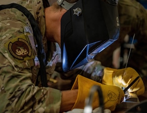 U.S. Air Force Chief Master Sgt. Markus Annis, 100th Communications Squadron senior enlisted leader, practices welding processes on pieces of stainless steel sheet metal for a non-destructive inspection during a Day in the Life immersion with the 100th Maintenance Squadron at RAF Mildenhall, England, June 13, 2025.