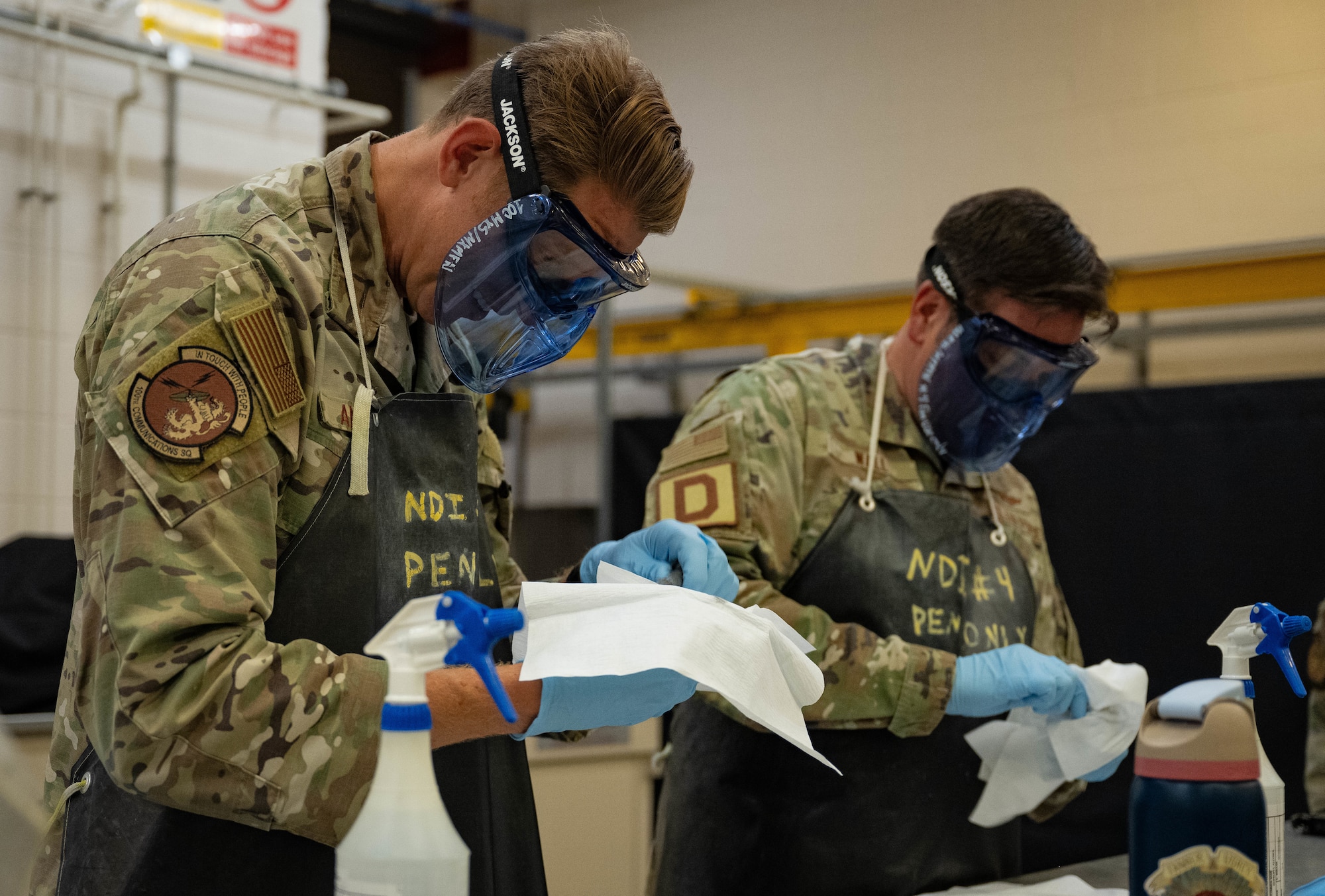 U.S. Air Force Col. Joseph Wall, right, 100th Air Refueling Wing deputy commander, and Chief Master Sgt. Markus Annis, 100th Communications Squadron senior enlisted leader, clean engine mount bolts with isopropyl alcohol during a Day in the Life immersion with the 100th Maintenance Squadron at RAF Mildenhall, England, June 13, 2025.