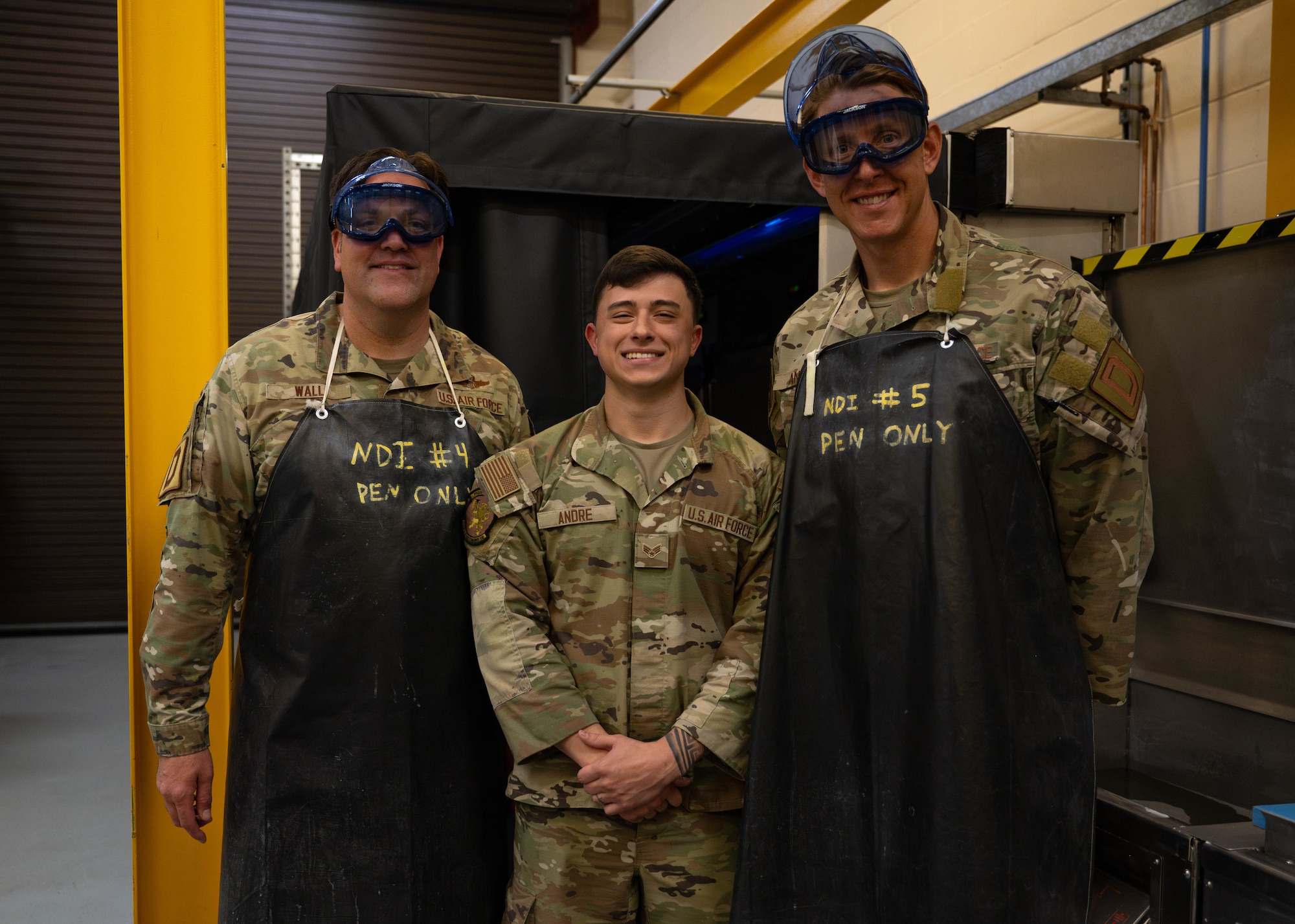 U.S. Air Force Col. Joseph Wall, left, 100th Air Refueling Wing deputy commander, Senior Airman Janzyn Andre, center, 100th Maintenance Squadron non-destructive inspection journeyman, and Chief Master Sgt. Markus Annis, 100th Communications Squadron senior enlisted leader, poses for a photo after a Day in the Life immersion with the 100th MXS at RAF Mildenhall, England, June 13, 2025.