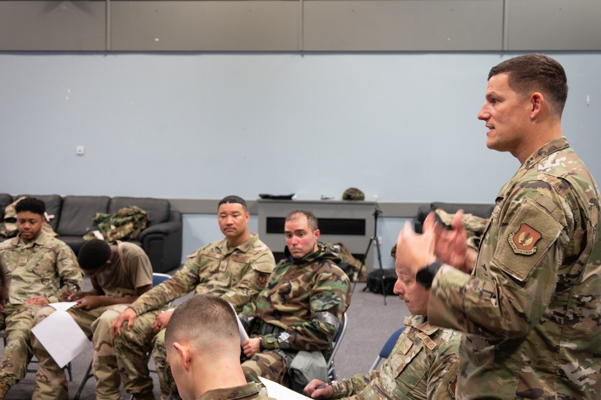 A speaker debriefs Airmen following the conclusion of Ready Airmen Training