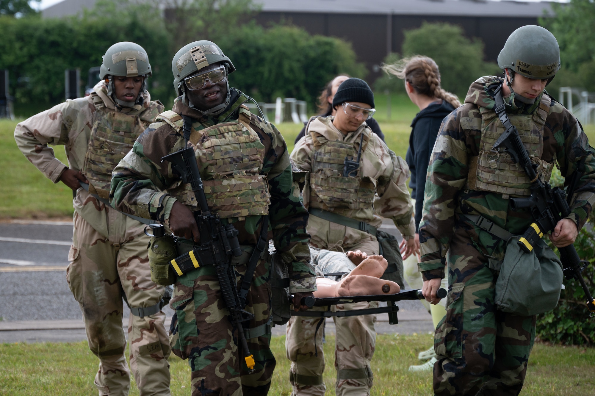 Members of the 501st Combat Support Wing carry a simulated casualty on a stretcher during Tactical Combat Casualty Care (TCCC) training