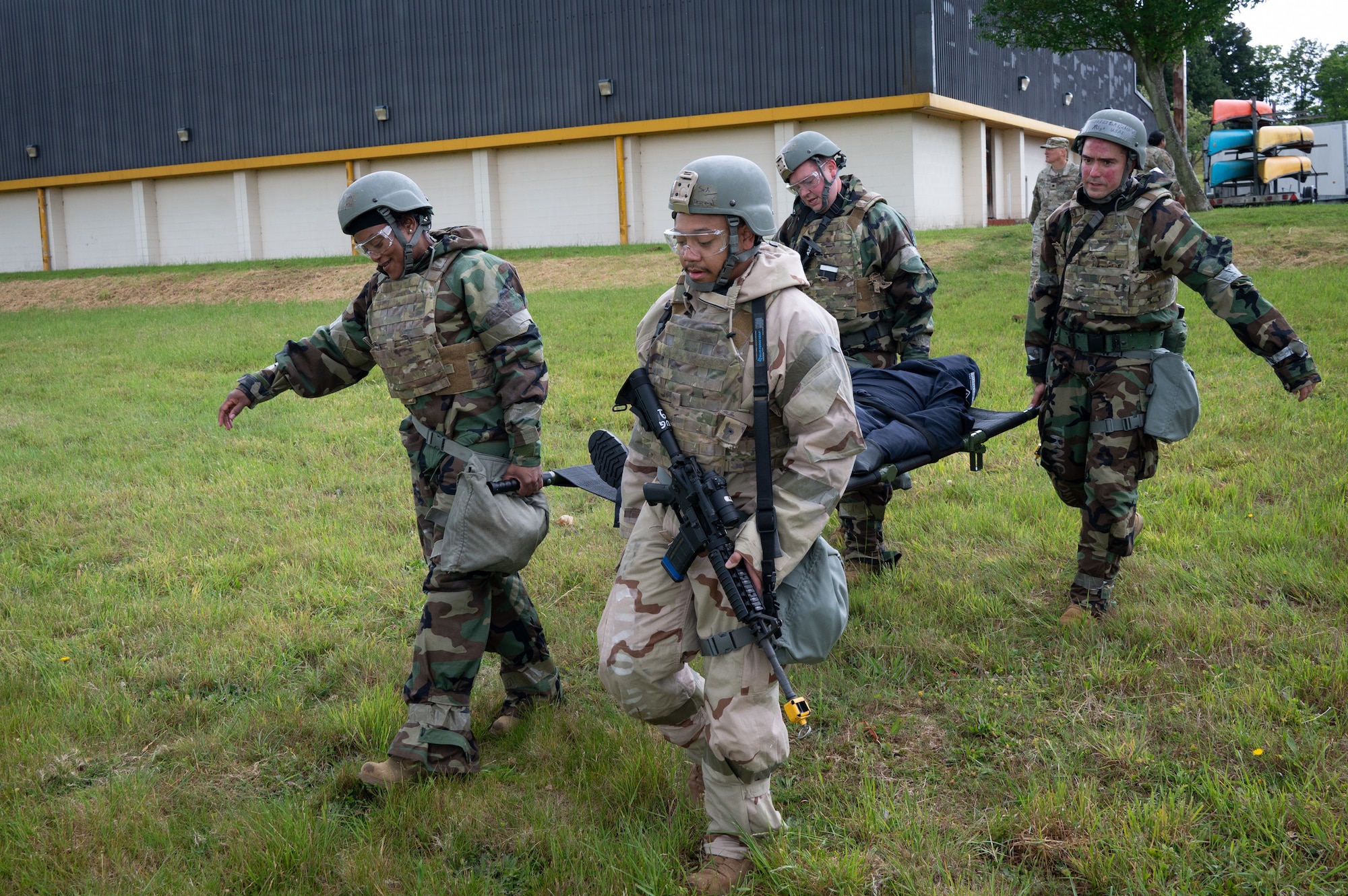 Members of the 501st Combat Support Wing carry a simulated casualty on a stretcher during Tactical Combat Casualty Care (TCCC) training