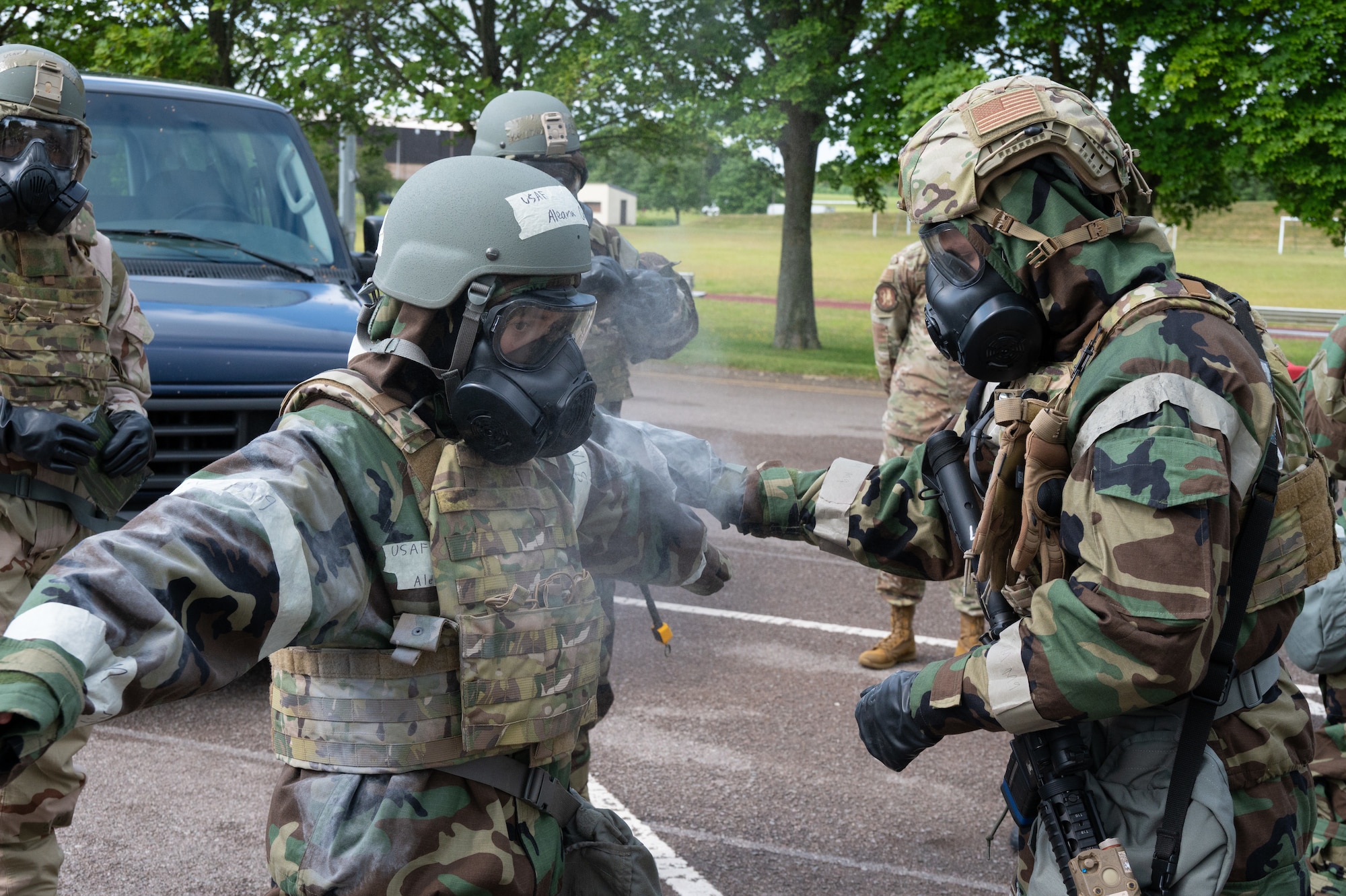 Members of the 501st Combat Support Wing perform buddy decontamination procedures during Chemical, Biological, Radiological and Nuclear (CBRN) training