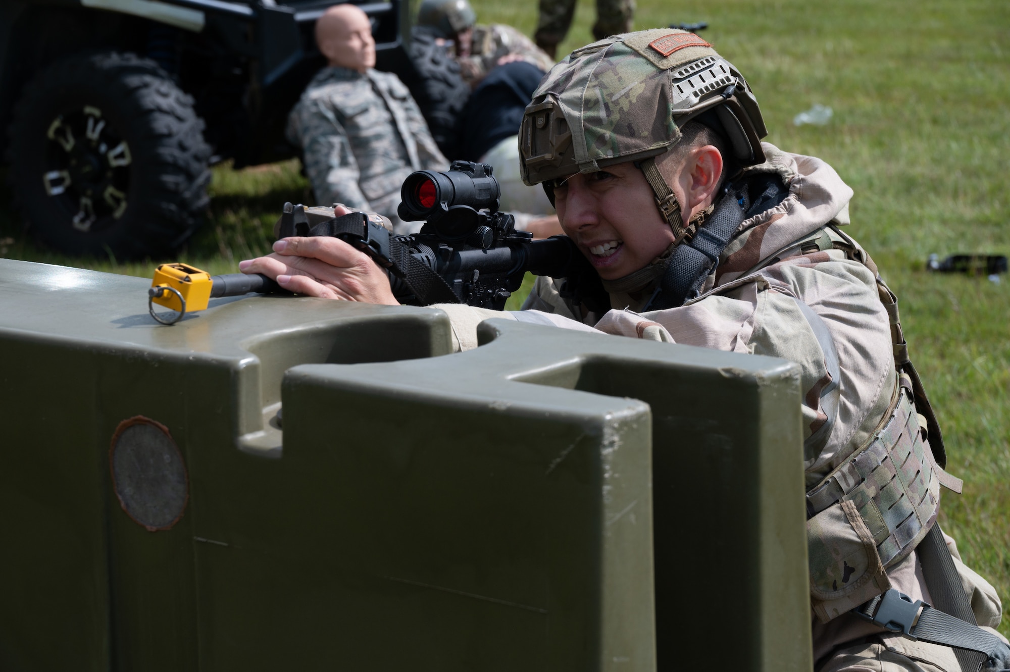 A member of the 501st Combat Support Wing aims a training rifle while reacting to a simulated ambush