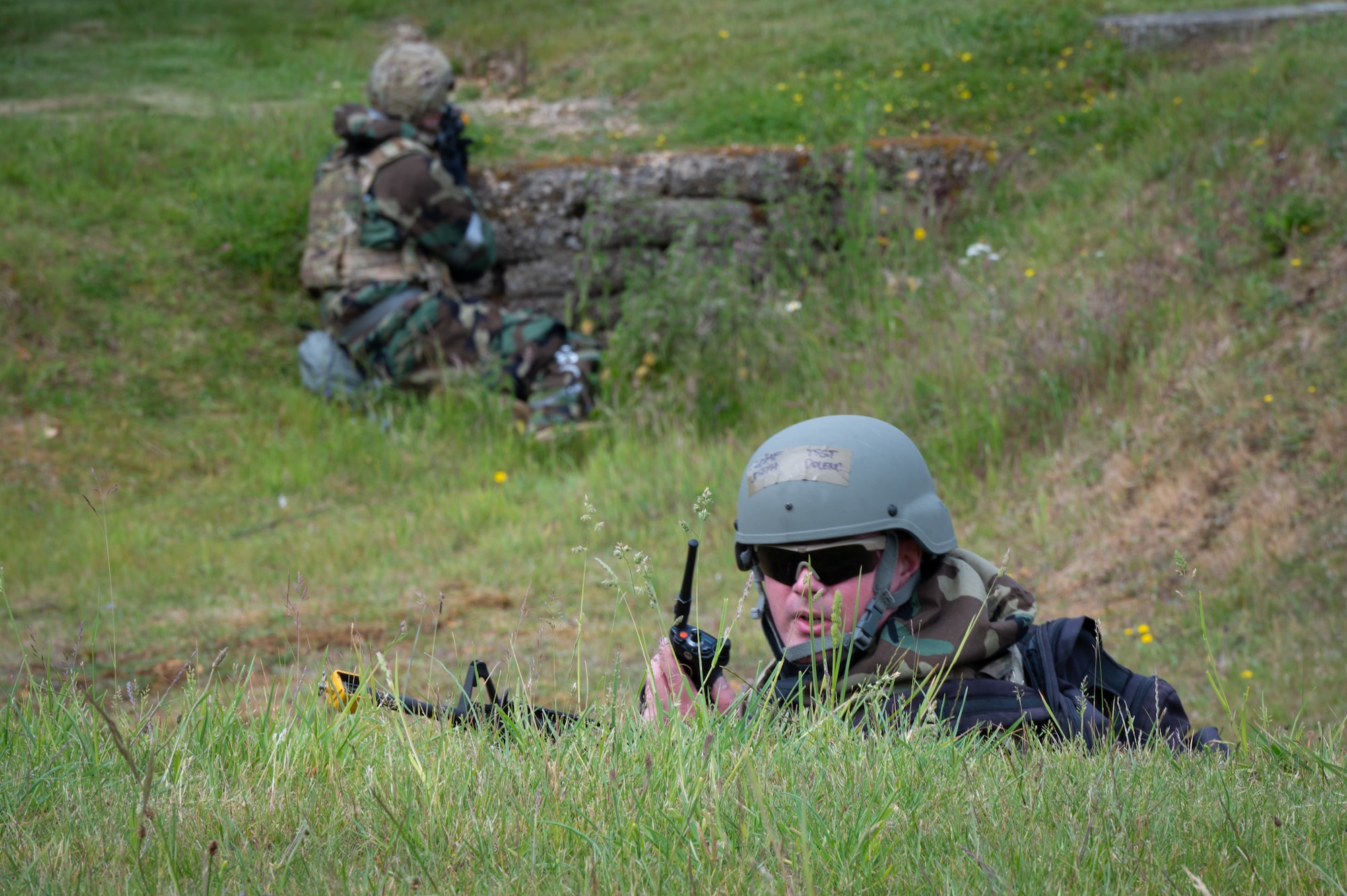Members of the 501st Combat Support Wing scan for simulated enemy movement