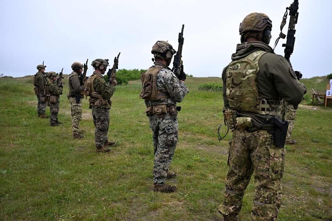U.S. Marines with Alpha Company, 2d Light Armored Reconnaissance Battalion, 2nd Marine Division and Portuguese service members prepare to fire HK416 high-performance-optimized assault rifles during exercise Baltic Operations 2025 (BALTOPS 25), June 11, 2025 in Liepaja, Latvia.  BALTOPS 25, the premier maritime-focused exercise in the Baltic Region, provides a unique training opportunity to strengthen combined response capabilities critical to preserving freedom of navigation and security in the Baltic Sea. (U.S. Marine Corps photo by Sgt. Alyssa Chuluda)