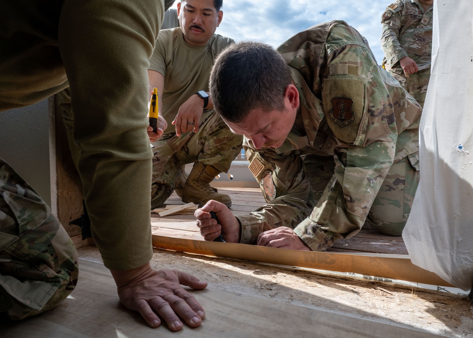 Master Sgt. Derek Senter, 141st Civil Engineer Squadron, operation management Non-Commissioned Officer In Charge, prepares a door frame inside Seward Military Resort's boathouse in Seward, Alaska, June 11, 2025.
