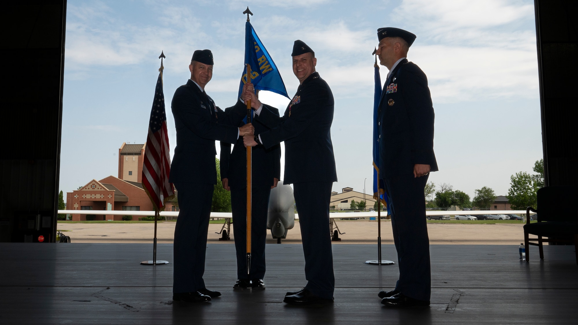 Col. Timothy Monroe, 319th Reconnaissance Wing commander, accepts the guidon from Col. Eric Steele, 319th Operations Group outgoing commander, during the 319th OG change of command ceremony at Grand Forks Air Force Base, N.D., June 13, 2025.