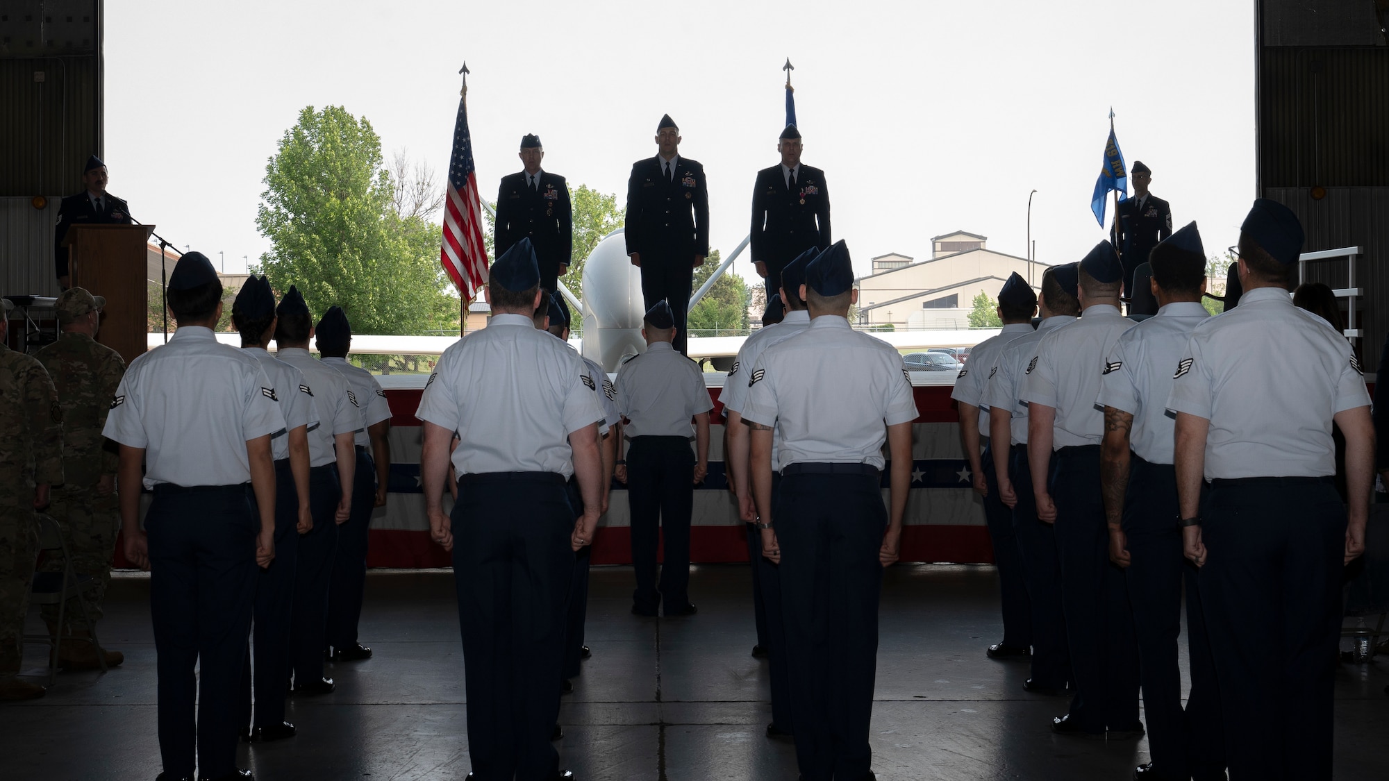 Airmen from the 319th Operations Group stand at attention during the Air Force song at the 319th OG change of command ceremony at Grand Forks Air Force Base, N.D., June 13, 2025.
