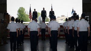 Airmen from the 319th Operations Group stand at attention during the Air Force song at the 319th OG change of command ceremony at Grand Forks Air Force Base, N.D., June 13, 2025.