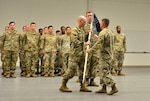 Captain Caleb D. Rogers, commander of the 111th Electromagnetic Warfare Company receives the recently uncased unit guidon from Lt. Col.  Luke E. Gurley, commander of the 221st Intelligence and Electronic Warfare Battalion, assuming his new role as commander during the company's activation ceremony June 7, 2025 in Forest Park, Ga. (U.S. Army photo by Charles A. Emmons)