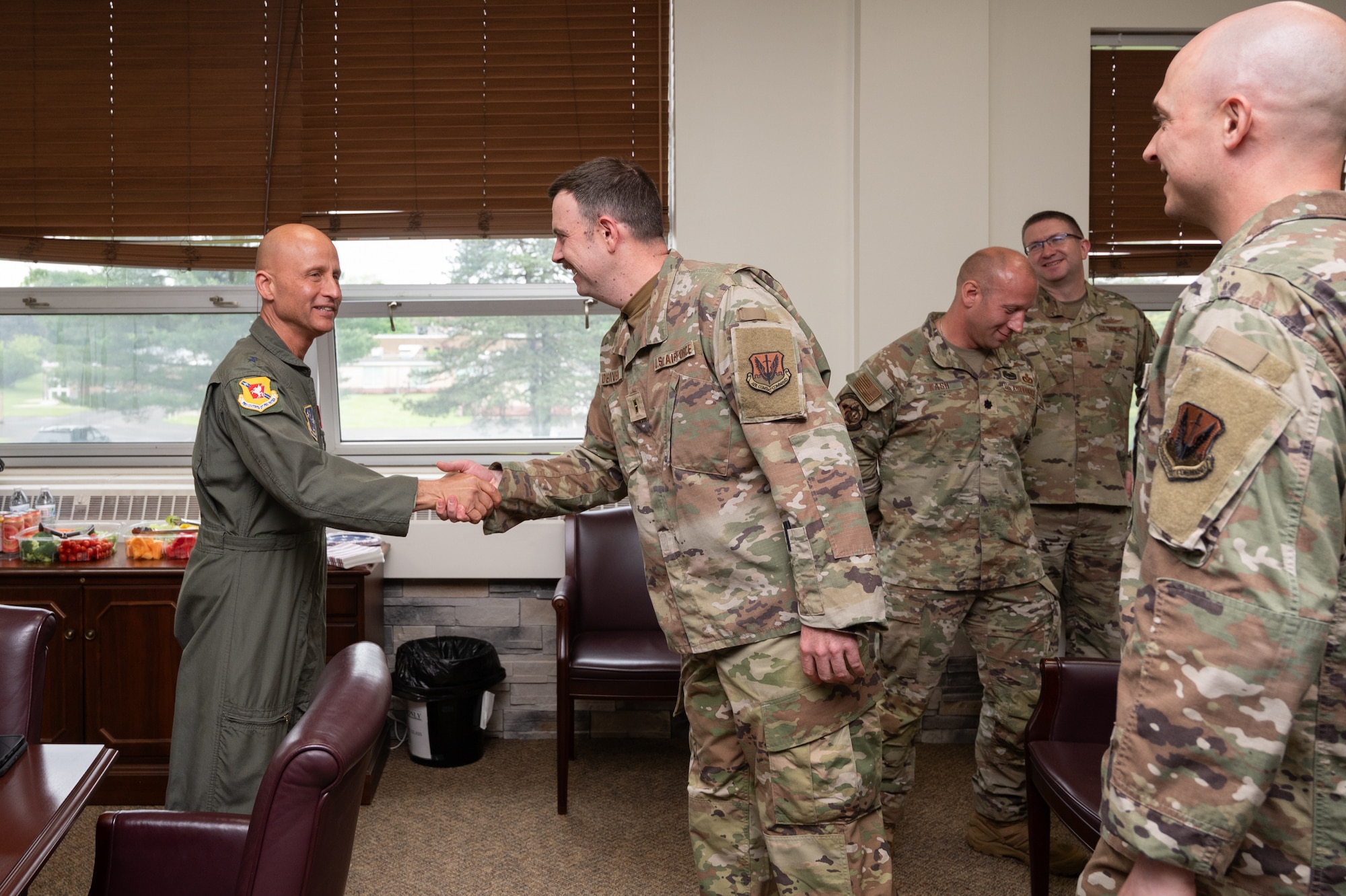 U.S. Air Force Maj. Gen. Terrence L. Koudelka, Jr., Deputy Adjutant General-Air and Commander of the Pennsylvania Air National Guard, coins Chief Warrant Officer 2 Jonathan DeRivera during a recognition event at Biddle Air National Guard Base, Pennsylvania, May 29, 2025.