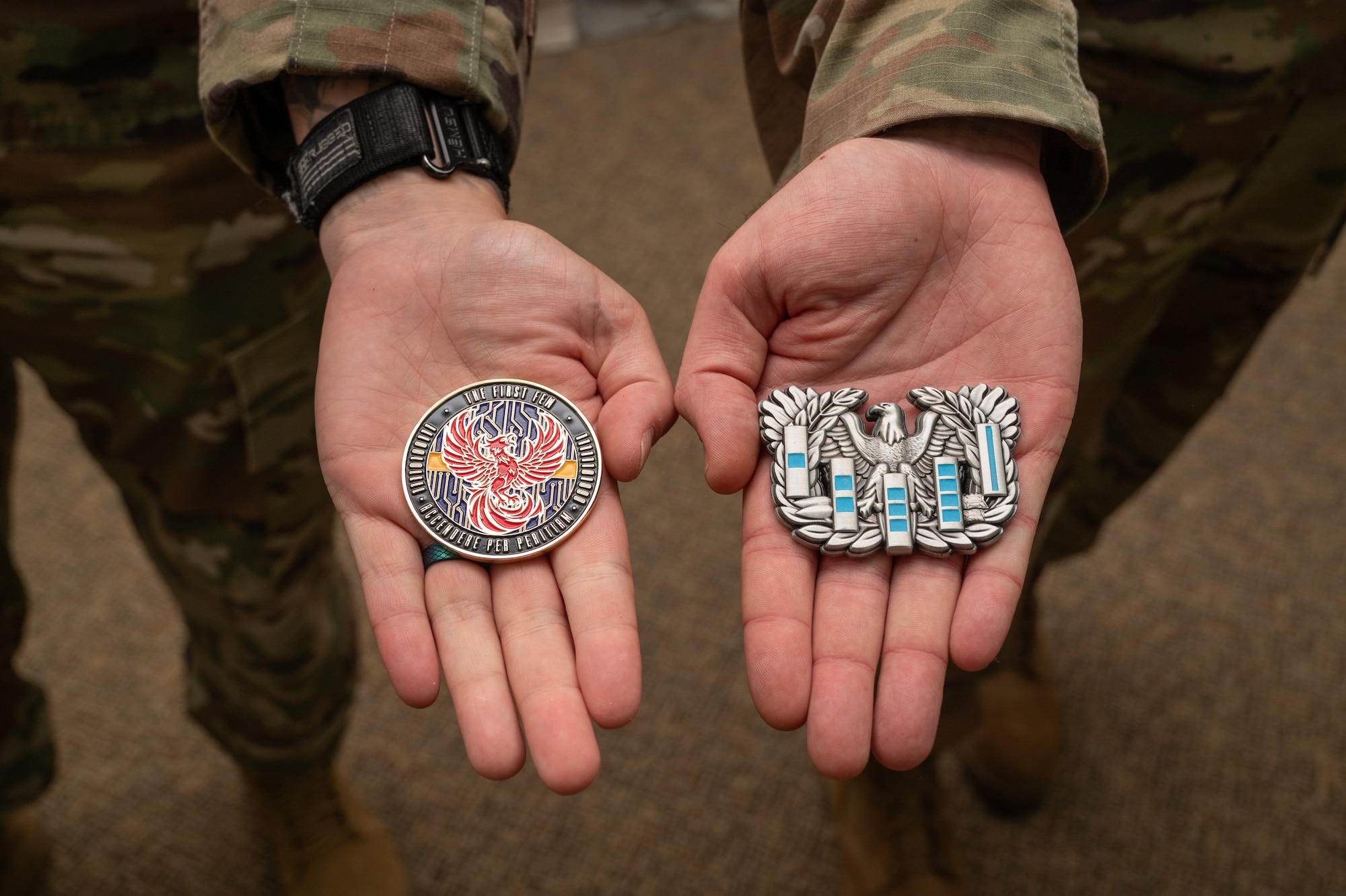 U.S. Air Force Chief Warrant Officers 2 Brian Mundorff and Jonathan DeRivera, the first appointed warrant officers in the Pennsylvania Air National Guard since the rank’s reinstatement, display symbolic challenge coins at Biddle Air National Guard Base, Pennsylvania, May 29, 2025.