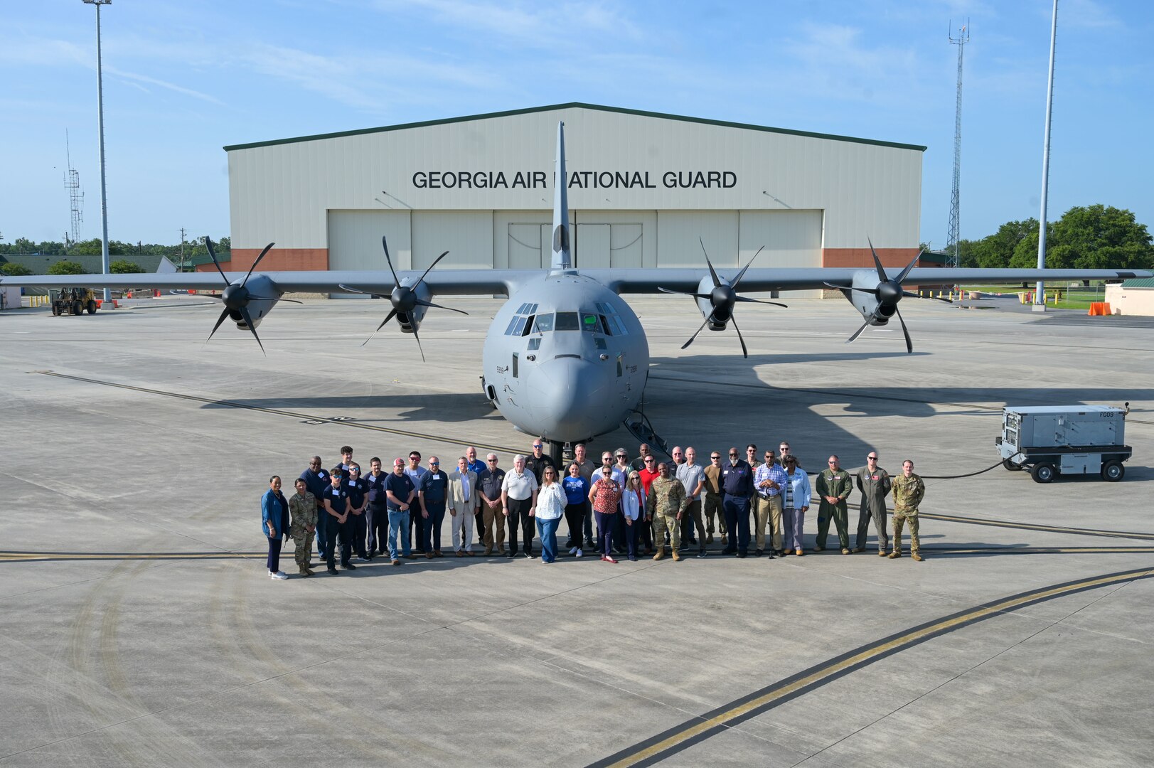 U.S. Airmen assigned to the 165th Airlift Wing (AW), Georgia Air National Guard, and civilian employers pose in front of the 165 AW C-130J Super Hercules, during an (ESGR) Boss Lift event hosted at Savannah Air National Guard Base, Georgia, June 11, 2025.