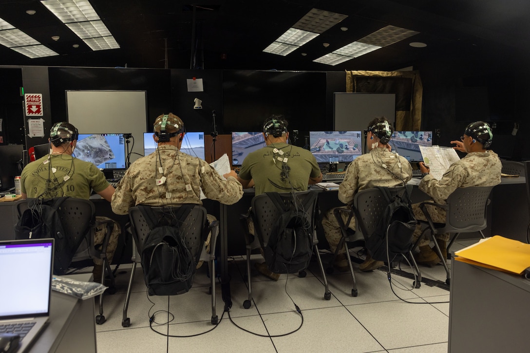 U.S. Marines with 3rd Light Armored Reconnaissance Battalion, 1st Marine Division, I Marine Expeditionary Force, prepare for training at the Battle Simulation Center, Marine Corps Air Ground Combat Center, Twentynine Palms, California, April 8, 2025. The Defense Advanced Research Project Agency’s partnership with MAGTFTC’s BSC and 1st MARDIV units represents a long-term investment in gaining a strategic edge by developing performance metrics for Fire Support Team training and enhancing systems like the  Joint Terminal Attack Controller Virtual Trainer. (U.S. Marine Corps photo by Cpl. Anna Higman)
