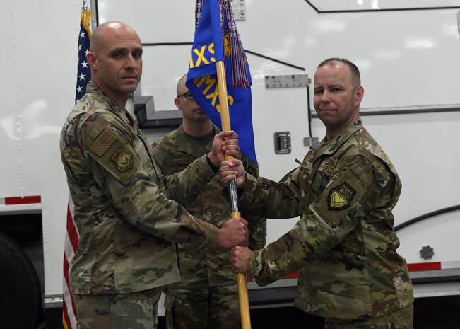 Lt. Col. Joshua Isom accepts command of the 341st Missile Maintenance Squadron during a ceremony June 13, 2025, at Malmstrom Air Force Base, Montana.