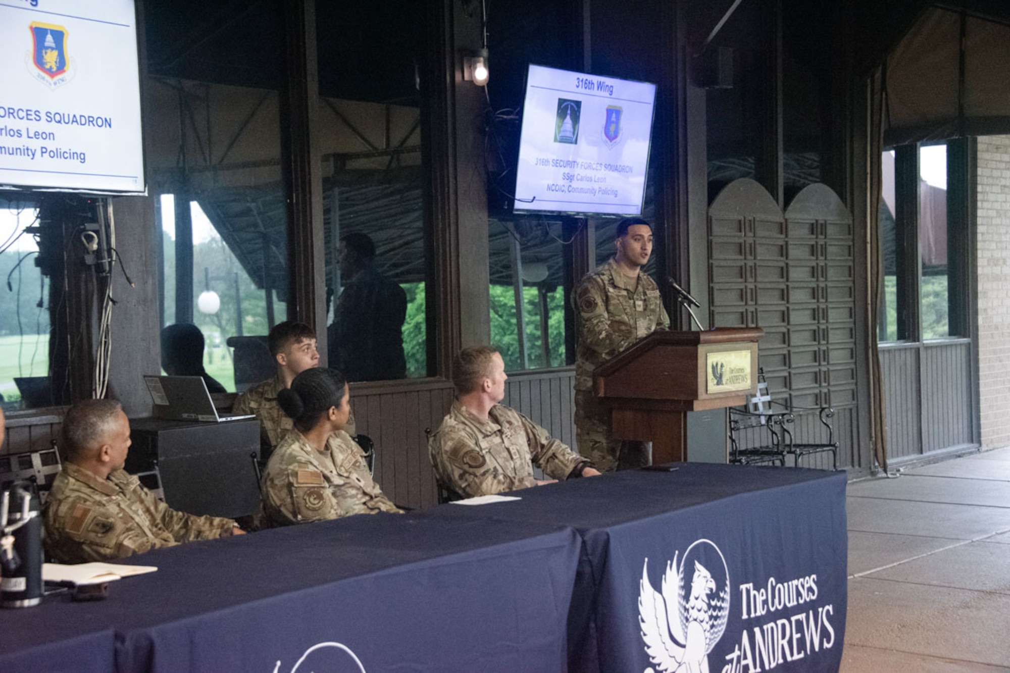 Staff Sgt. Carlos Leon provides security updates during a town hall.
