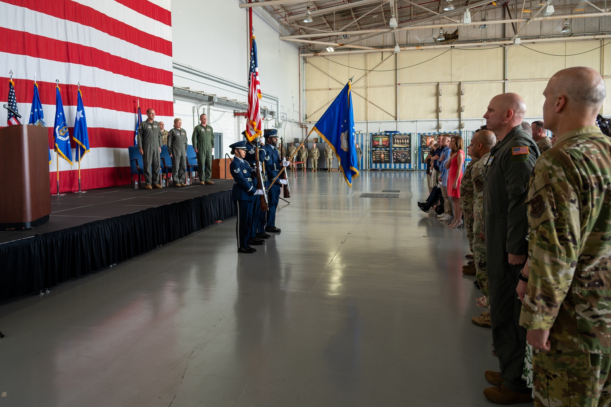 a military honor guard team presents the colors during a military ceremony