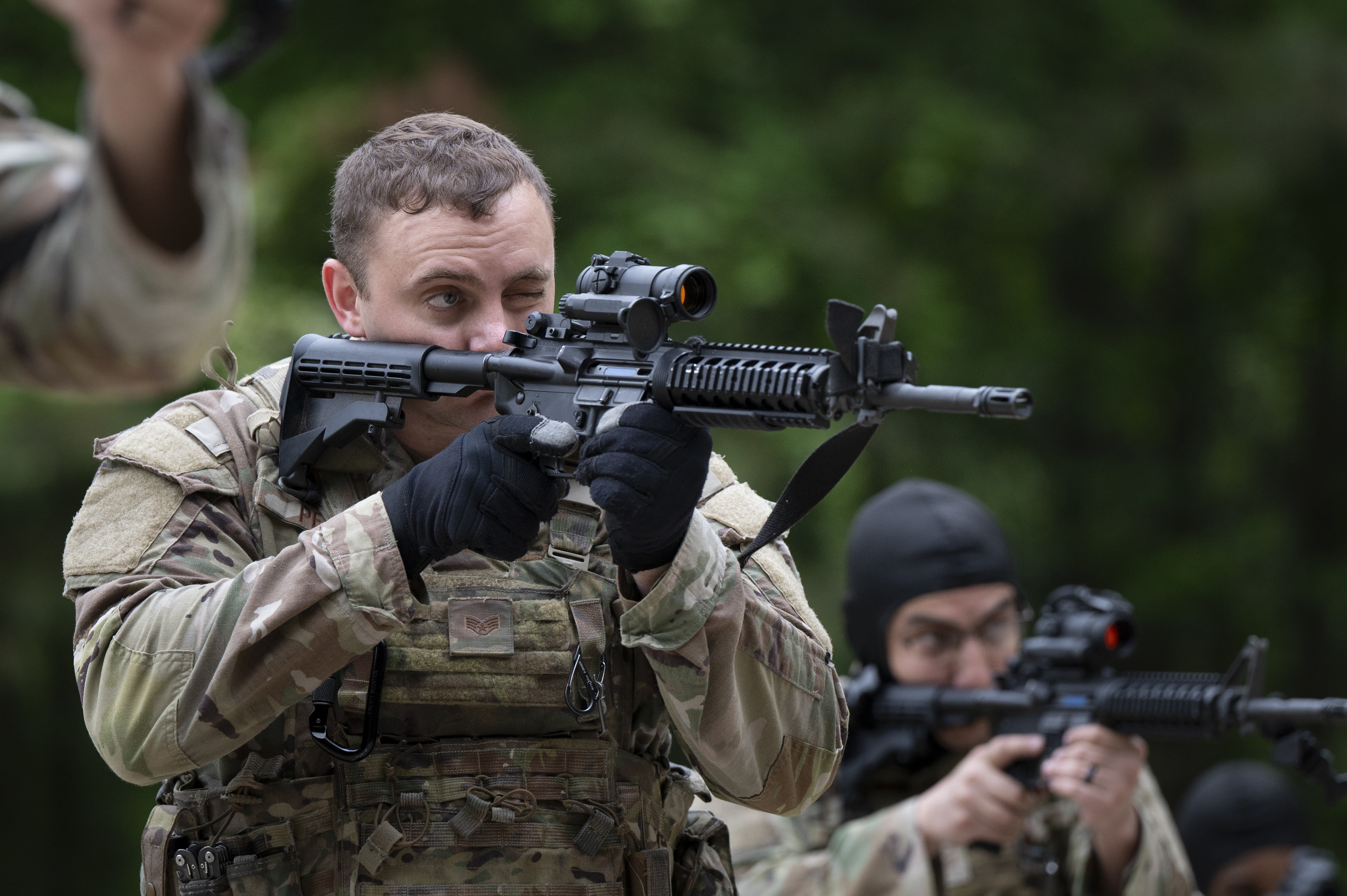 U.S. Air Force Staff Sgt. Nicholas Pfau, 94th Security Forces Squadron response force member, looks through the scope on his weapon at Dobbins Air Reserve Base, Ga., May 7, 2025, during a training exercise aimed at honing Defenders’ tactical skills and readiness. The exercise included the use of simulated munitions to mimic realistic combat conditions without the use of live ammunition. (U.S. Air Force photo by Staff Sgt. Gage Daniel)