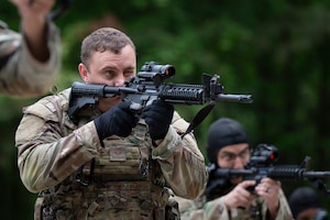 Security Forces members aim their weapons.