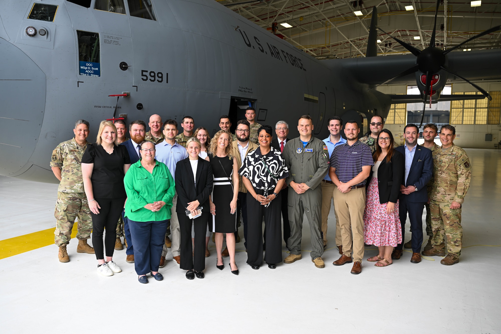 Staff members from various Ohio federal and state offices pose for a photo with Col. Chris Sedlacek, 910th Airlift Wing commander, and Citizen Airmen in front of a C-130J Super Hercules during a visit to Youngstown Air Reserve Station, Ohio, June 13, 2025.