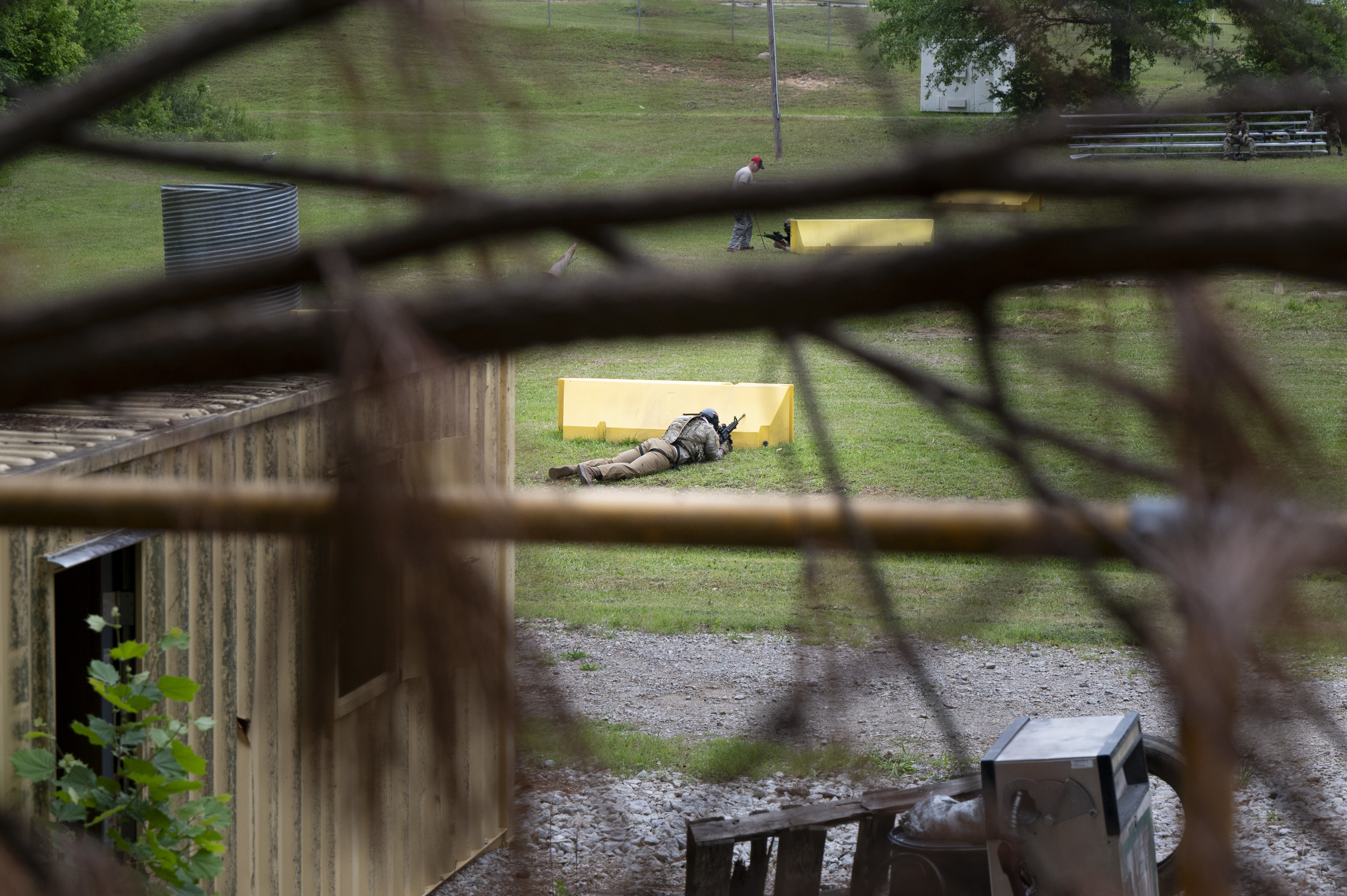 A U.S. Airman assigned to the 94th Security Forces Squadron takes cover during a security forces training event at Dobbins Air Reserve Base, Ga., May 7, 2025. The training emphasized team coordination, situational awareness and a focus on restoring the warrior ethos during high-stress and mentally demanding environments. (U.S. Air Force photo by Staff Sgt. Gage Daniel)
