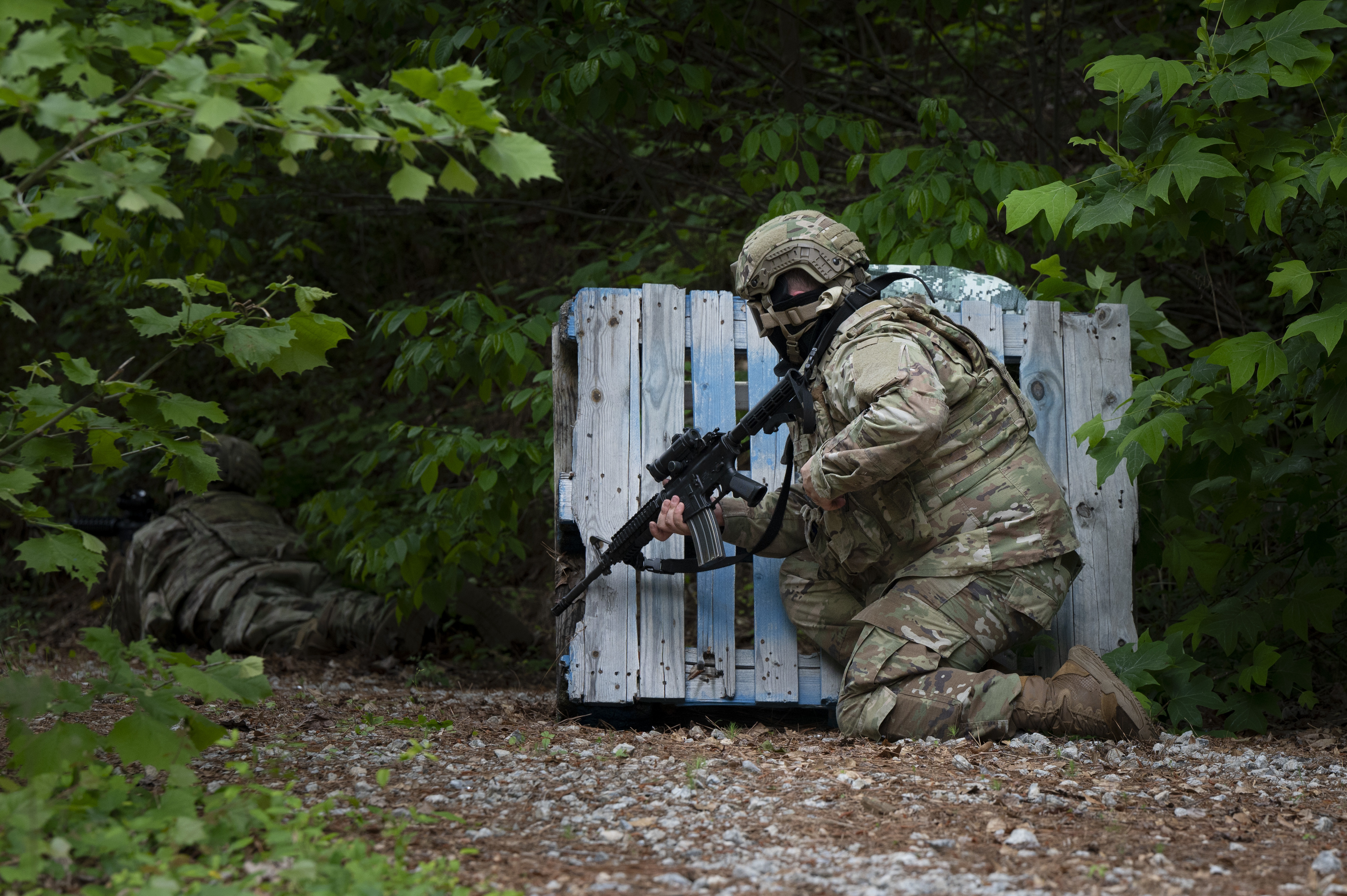 A U.S. Air Force 94th Security Forces Squadron response force member takes cover at Dobbins Air Reserve Base, Ga., May 7, 2025, during a security forces training exercise. The “Shoot, Move, Communicate” exercises align with key Department of Defense objectives to sustain a capable and lethal force, ensuring our Airmen are ready and trained to provide deterrence capabilities anywhere, any time. (U.S. Air Force photo by Staff Sgt. Gage Daniel)