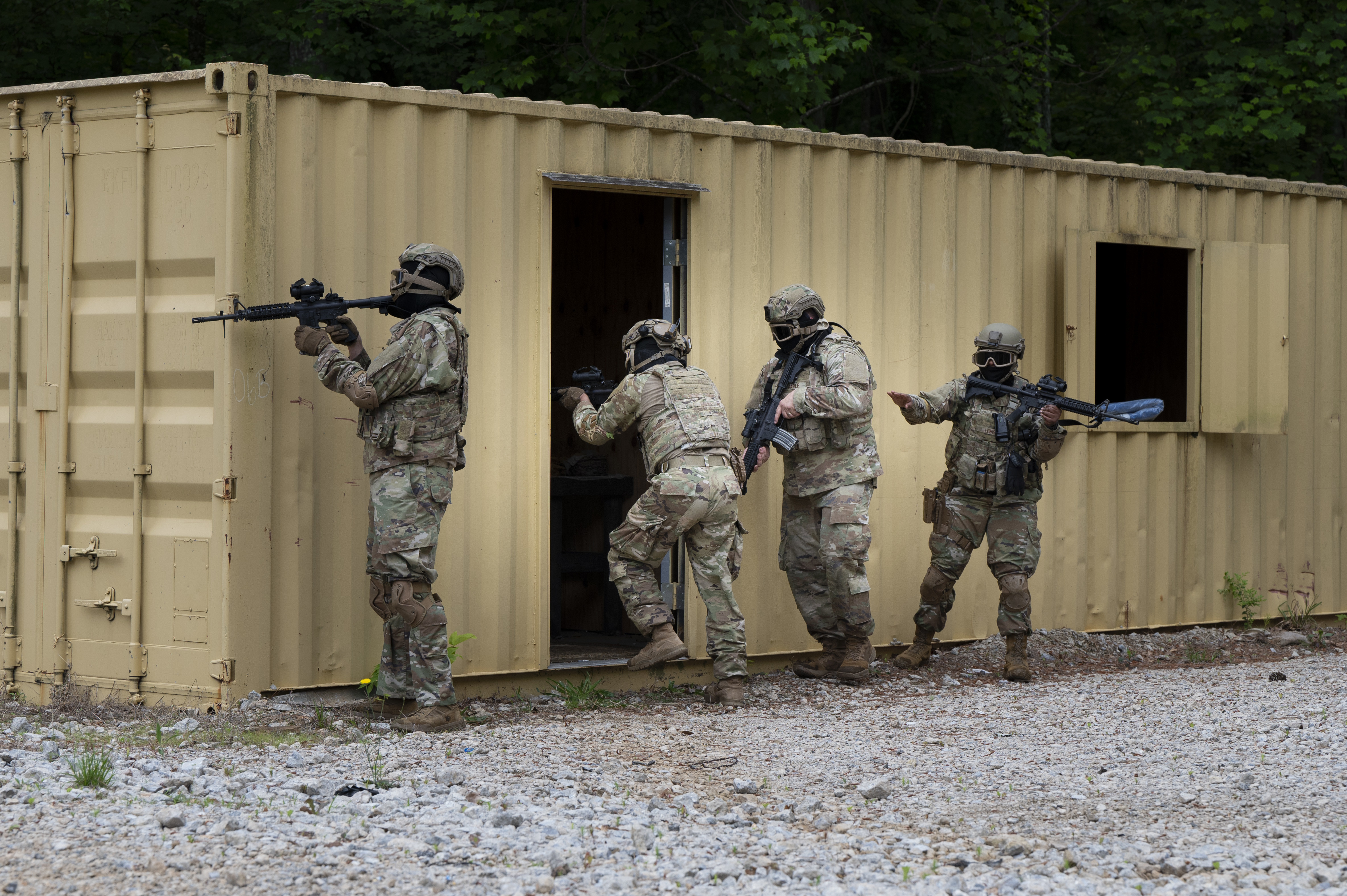 U.S. Air Force 94th Security Forces Squadron response force members prepare to clear opposing forces from a building at Dobbins Air Reserve Base, Ga., May 7, 2025, during a training event. Airmen participating in the training engaged in coordinated movement and fire under stress-inducing conditions to restore the warrior ethos and maintain readiness and mission competency at all times. (U.S. Air Force photo by Staff Sgt. Gage Daniel)