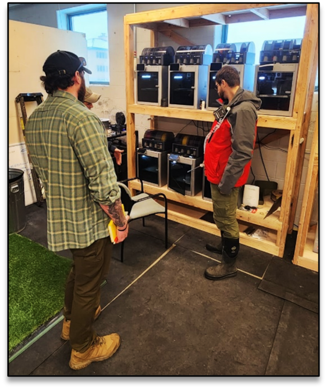 Justin McNabb (NWS) and Seth Chiles (NWK) assess 3D printers in the ATOC to determine air quality and HVAC requirement to ensure hazardous fumes are not present for 10th SFG personnel.