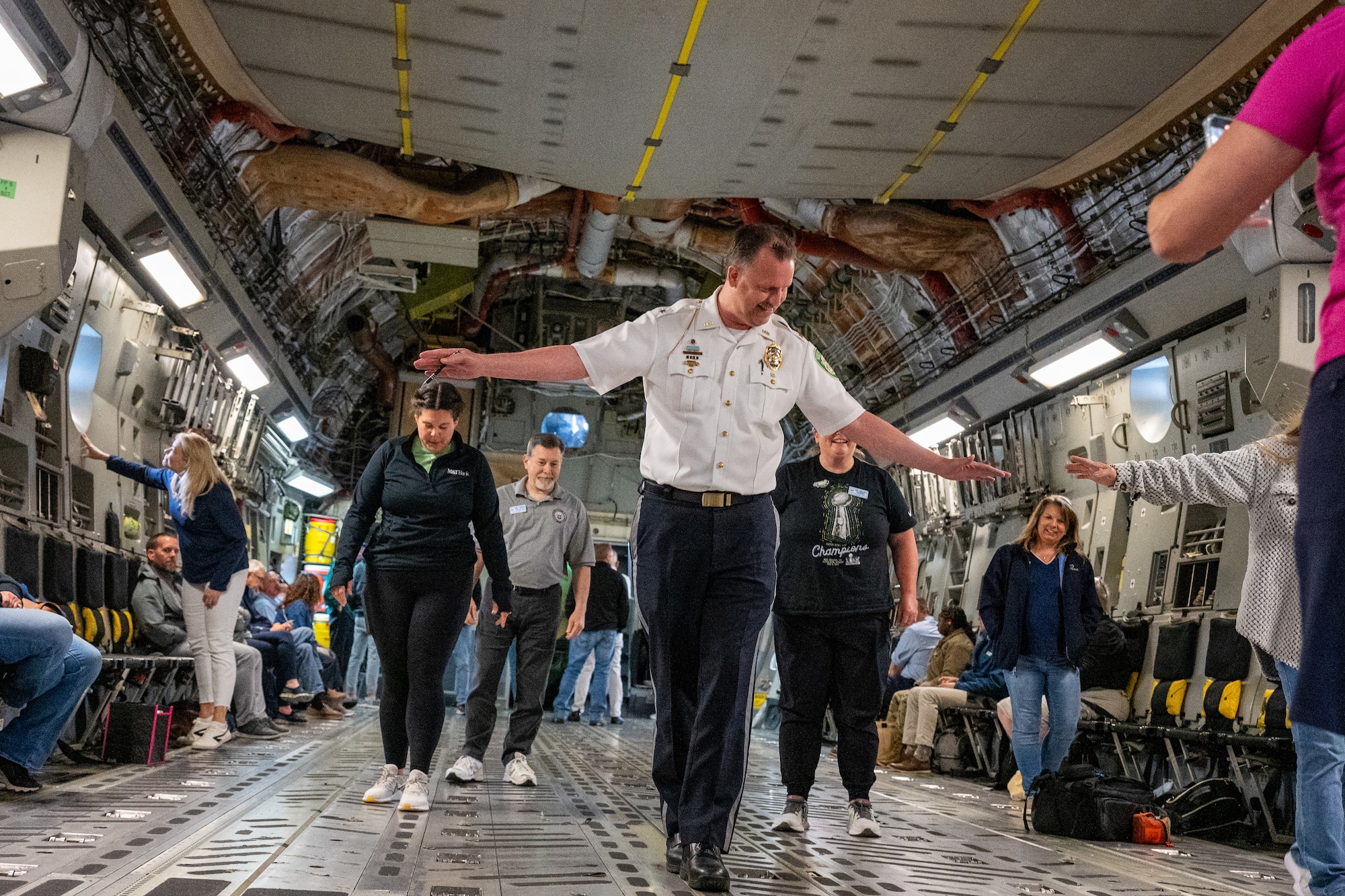 Chief Thomas Johnson, 436th Security Forces Squadron honorary commander and Dover Police Department chief of police, attempts to walk a straight line during turbulence on a C-17 Globemaster III orientation flight at Dover Air Force Base, Delaware, June 10, 2025.