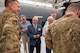 Mayors from around Florida's Emerald Coast receive a patch from a squadron attached to the 919th Special Operations Wing in front of an AC-130J on May 30, 2025. The purpose of the visit was to acquaint civic leaders with the unique mission of the 919th Special Operations Wing.