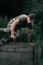Man jumping over a wall in a military obstacle course.